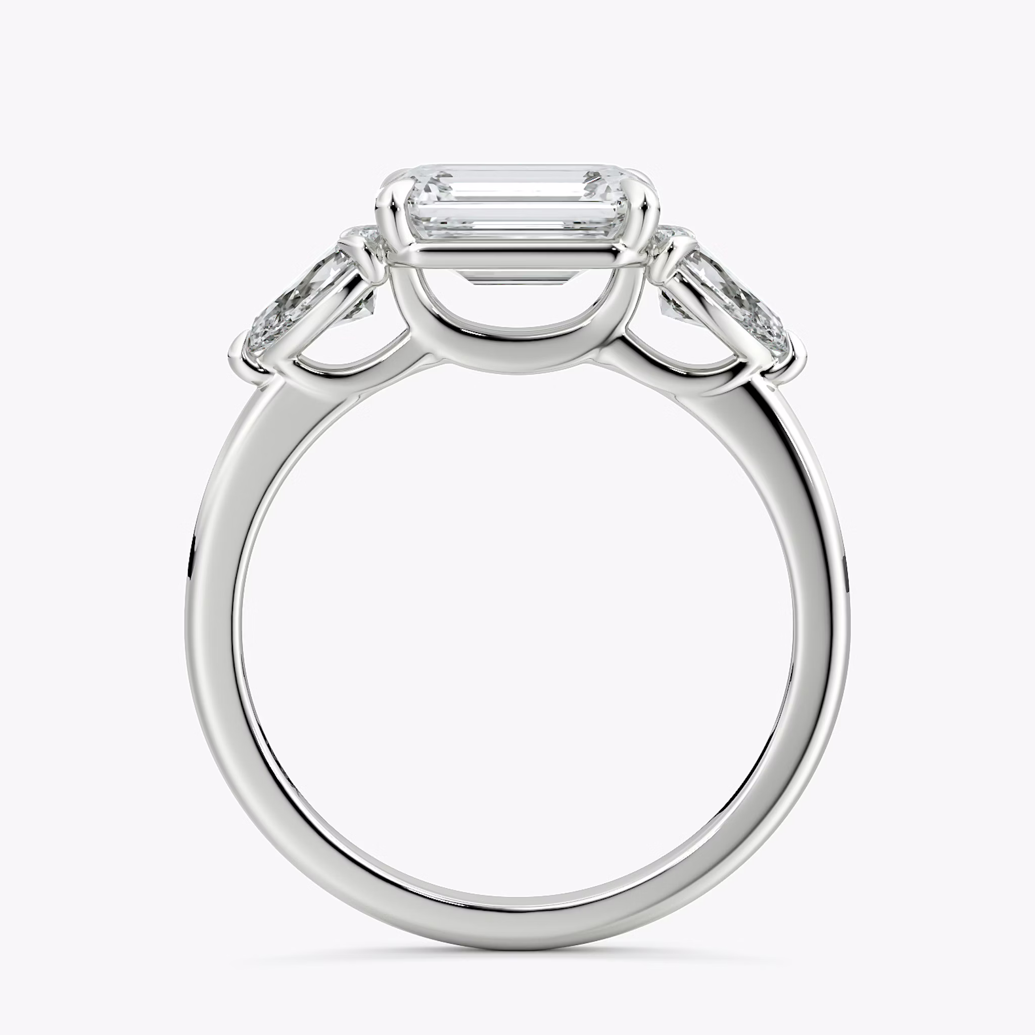 The Three Stone | Emerald | 18k | White Gold | bandAccent: Plain | diamondOrientation: horizontal | sideStoneCarat: 0.25ct | sideStoneShape: Pear | caratWeight: other