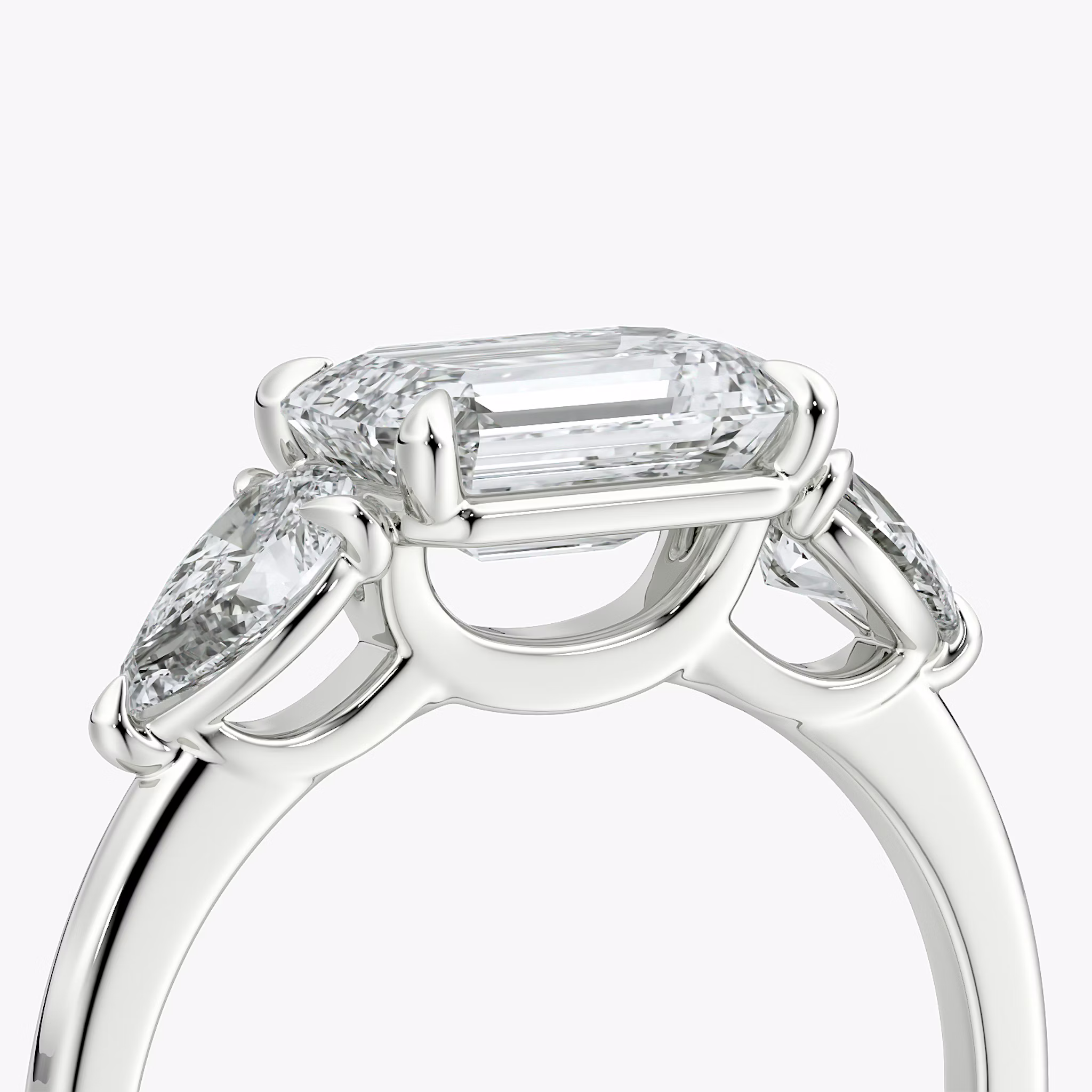 The Three Stone | Emerald | 18k | White Gold | bandAccent: Plain | diamondOrientation: horizontal | sideStoneCarat: 0.25ct | sideStoneShape: Pear | caratWeight: other