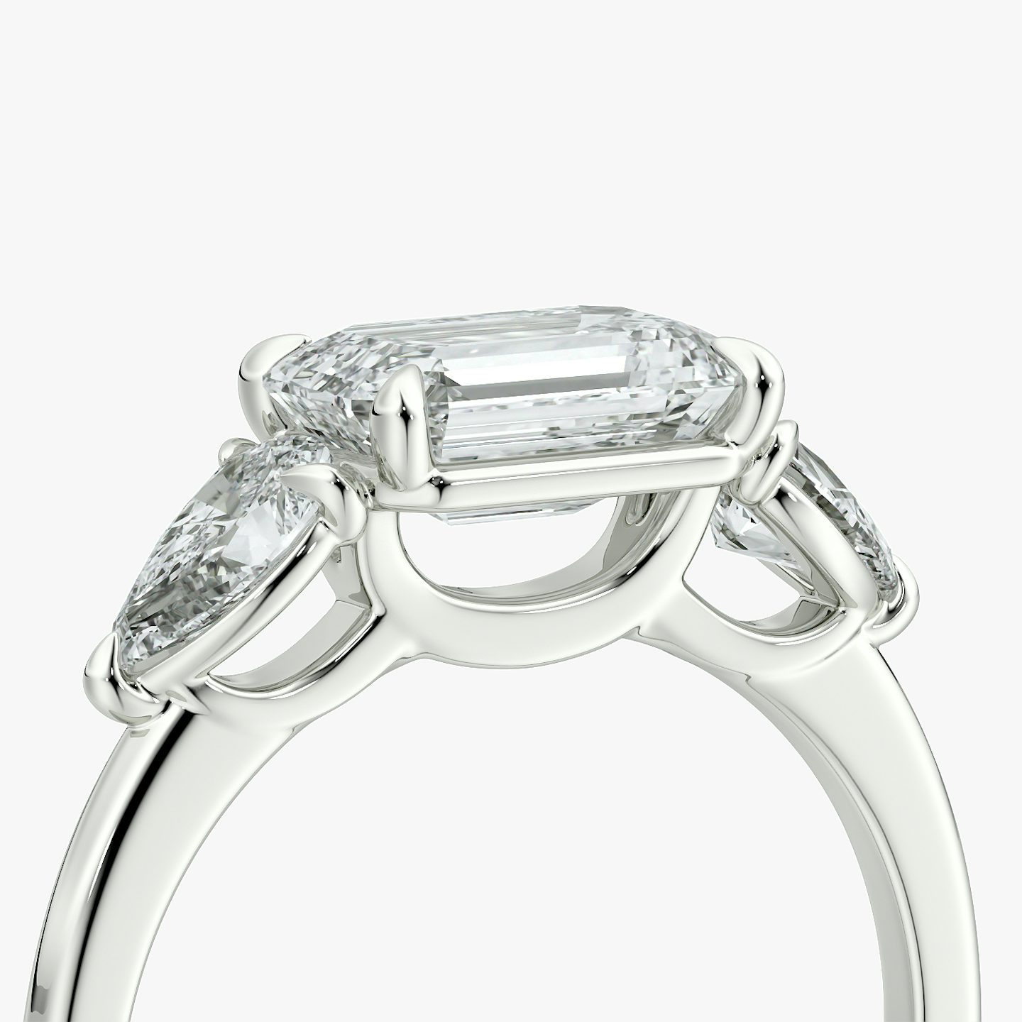 The Three Stone | Emerald | 18k | White Gold | bandAccent: Plain | diamondOrientation: horizontal | sideStoneCarat: 0.25ct | sideStoneShape: Pear | caratWeight: other