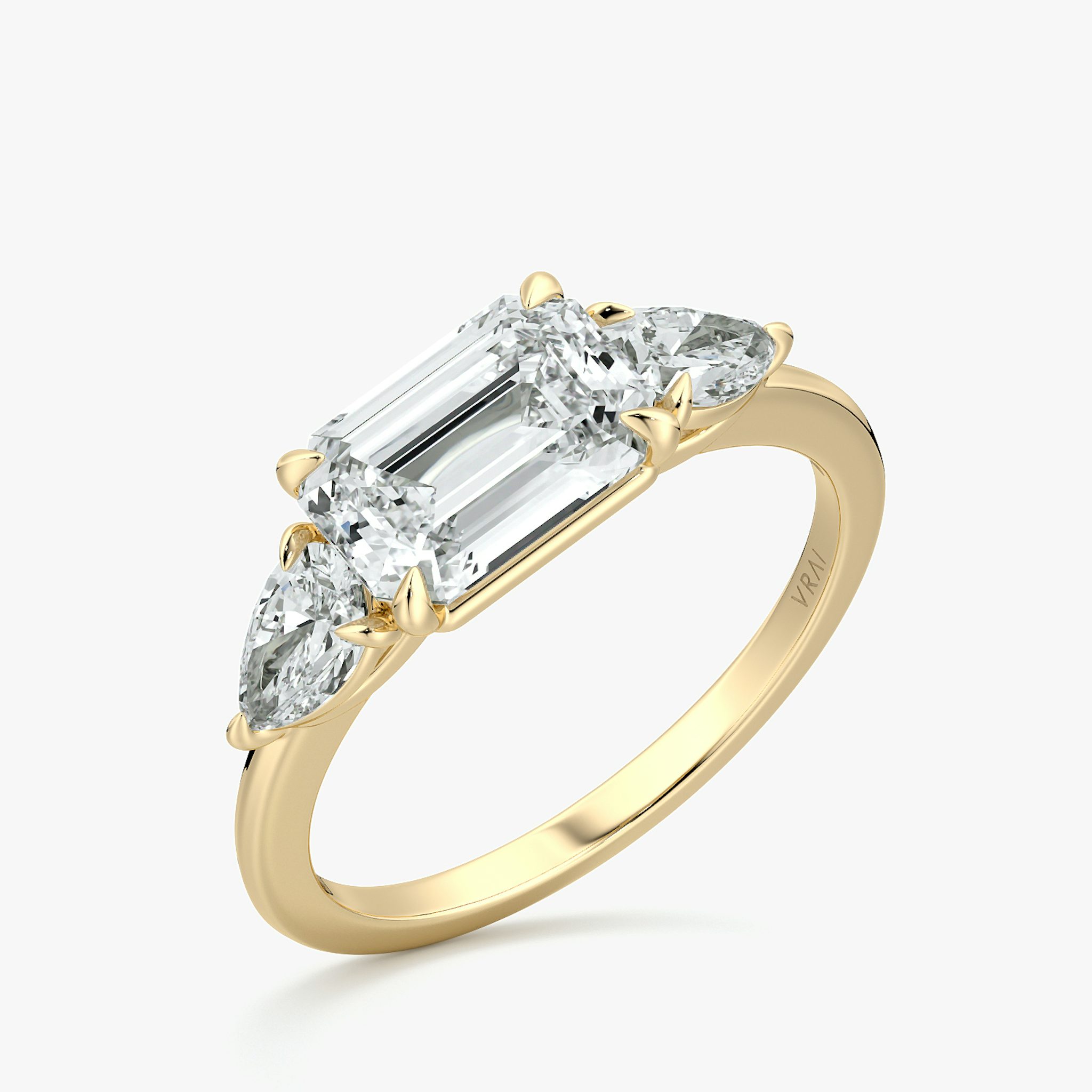 The Three Stone | Emerald | 18k | Yellow Gold | bandAccent: Plain | diamondOrientation: horizontal | sideStoneCarat: 0.25ct | sideStoneShape: Pear | caratWeight: other