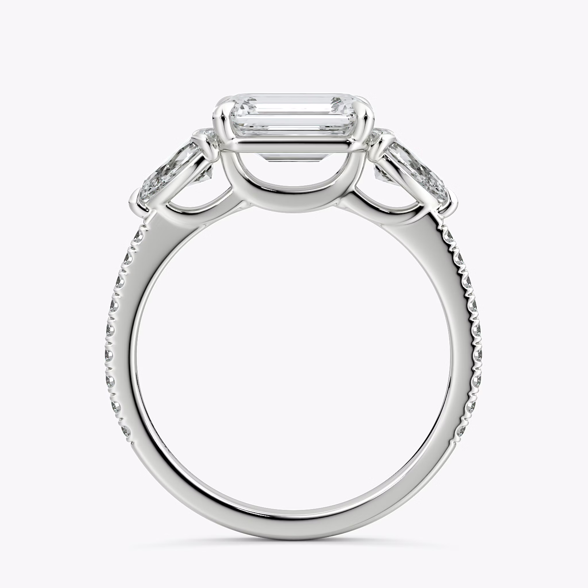 The Three Stone | Emerald | Platinum | bandAccent: Pavé | diamondOrientation: horizontal | sideStoneCarat: 0.25ct | sideStoneShape: Pear | caratWeight: other