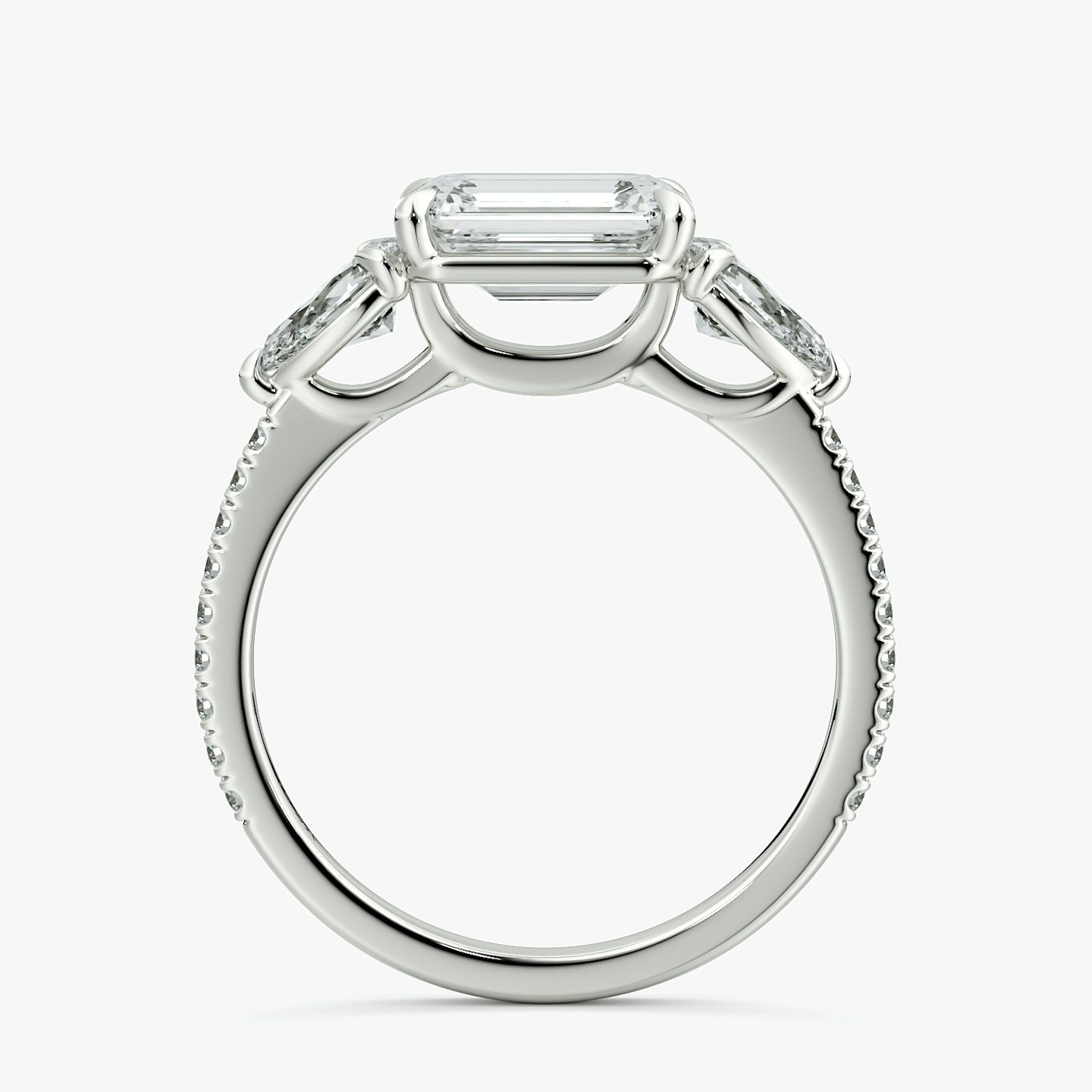 The Three Stone | Emerald | Platinum | bandAccent: Pavé | diamondOrientation: horizontal | sideStoneCarat: 0.25ct | sideStoneShape: Pear | caratWeight: other