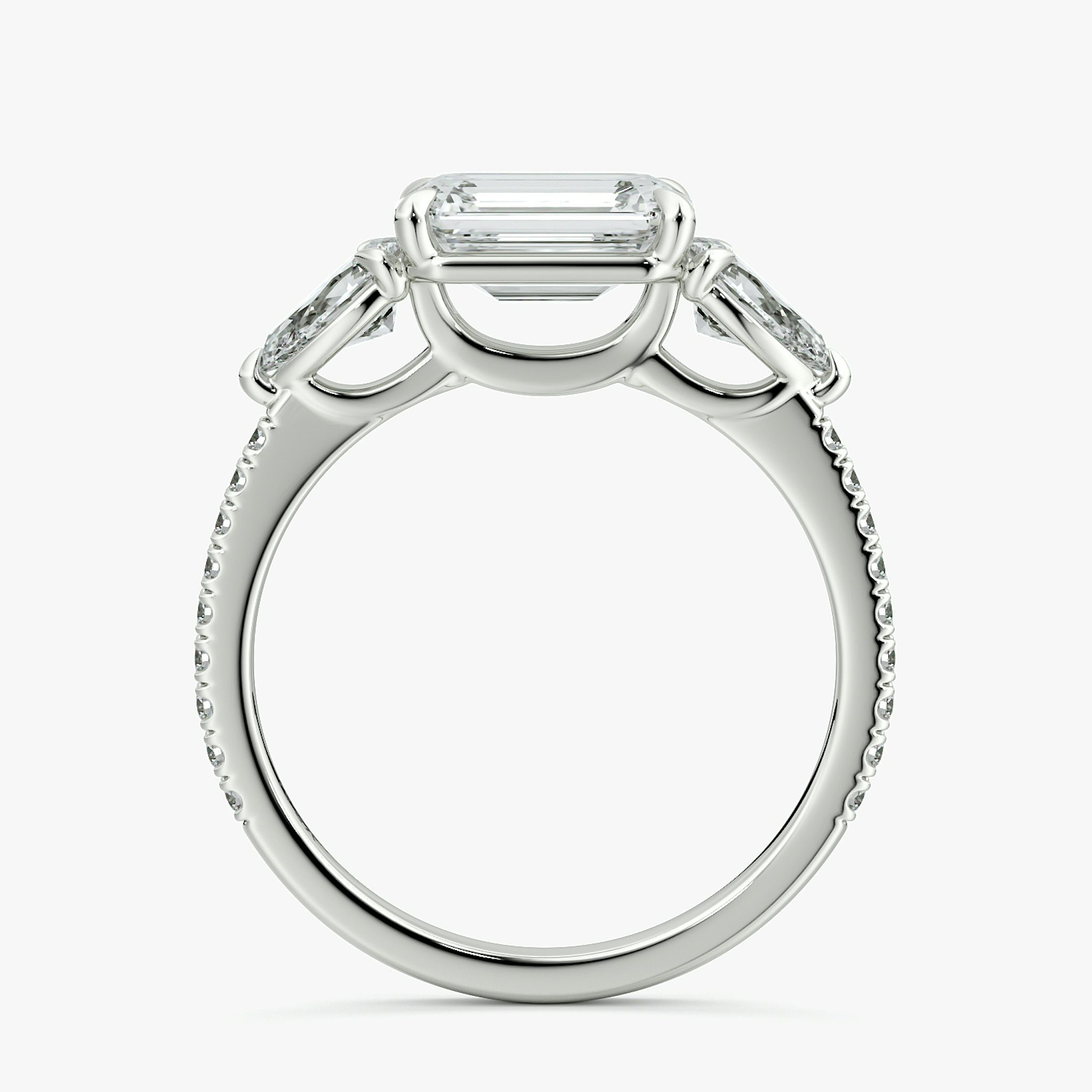 The Three Stone | Emerald | Platinum | bandAccent: Pavé | diamondOrientation: horizontal | sideStoneCarat: 0.25ct | sideStoneShape: Pear | caratWeight: other