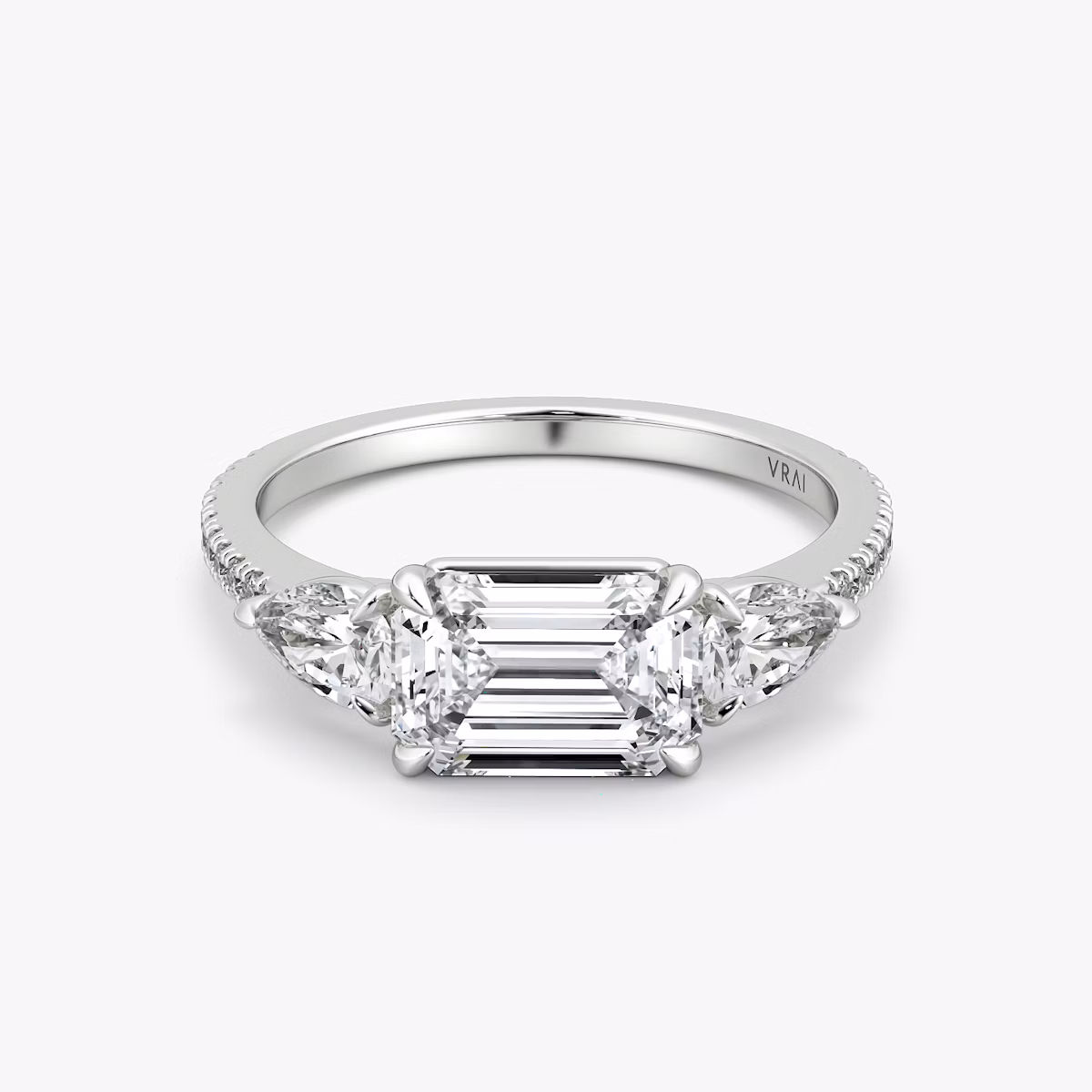 The Three Stone | Emerald | 18k | White Gold | bandAccent: Pavé | diamondOrientation: horizontal | sideStoneCarat: 0.25ct | sideStoneShape: Pear | caratWeight: other