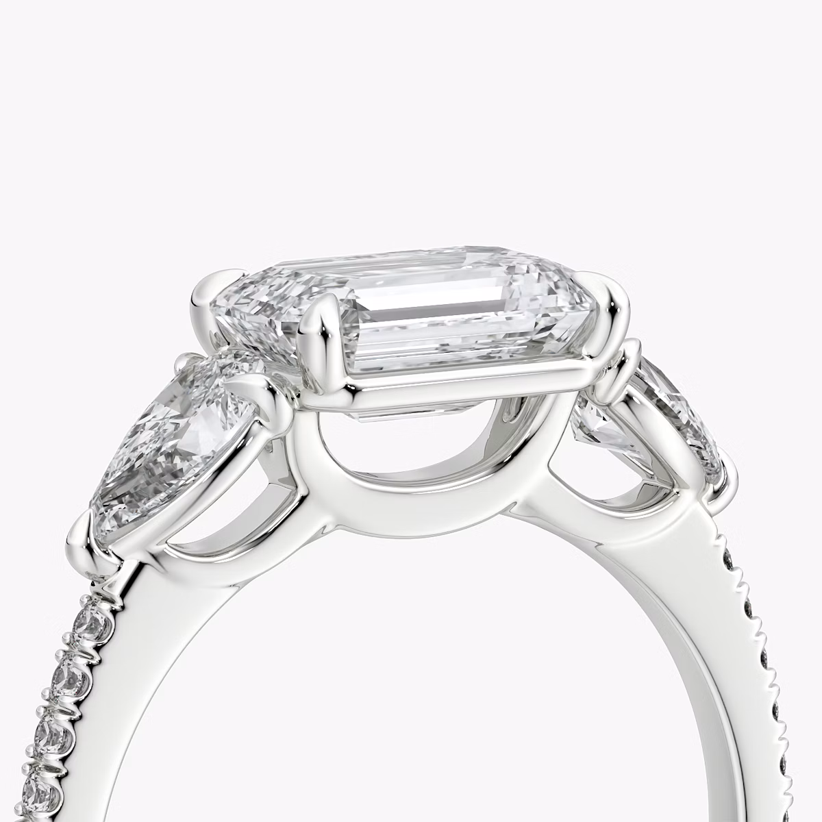The Three Stone | Emerald | 18k | White Gold | bandAccent: Pavé | diamondOrientation: horizontal | sideStoneCarat: 0.25ct | sideStoneShape: Pear | caratWeight: other