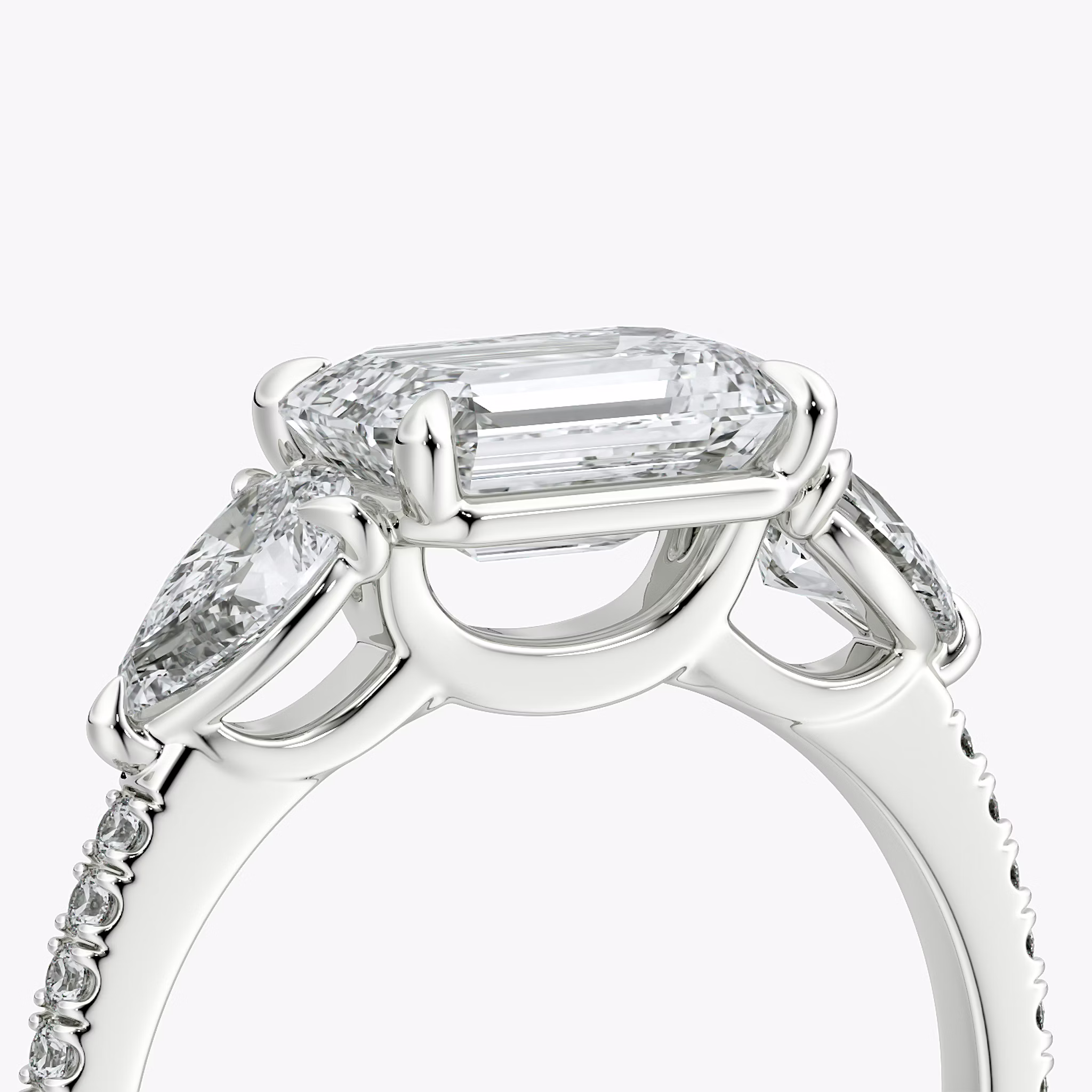 The Three Stone | Emerald | Platinum | bandAccent: Pavé | diamondOrientation: horizontal | sideStoneCarat: 0.25ct | sideStoneShape: Pear | caratWeight: other