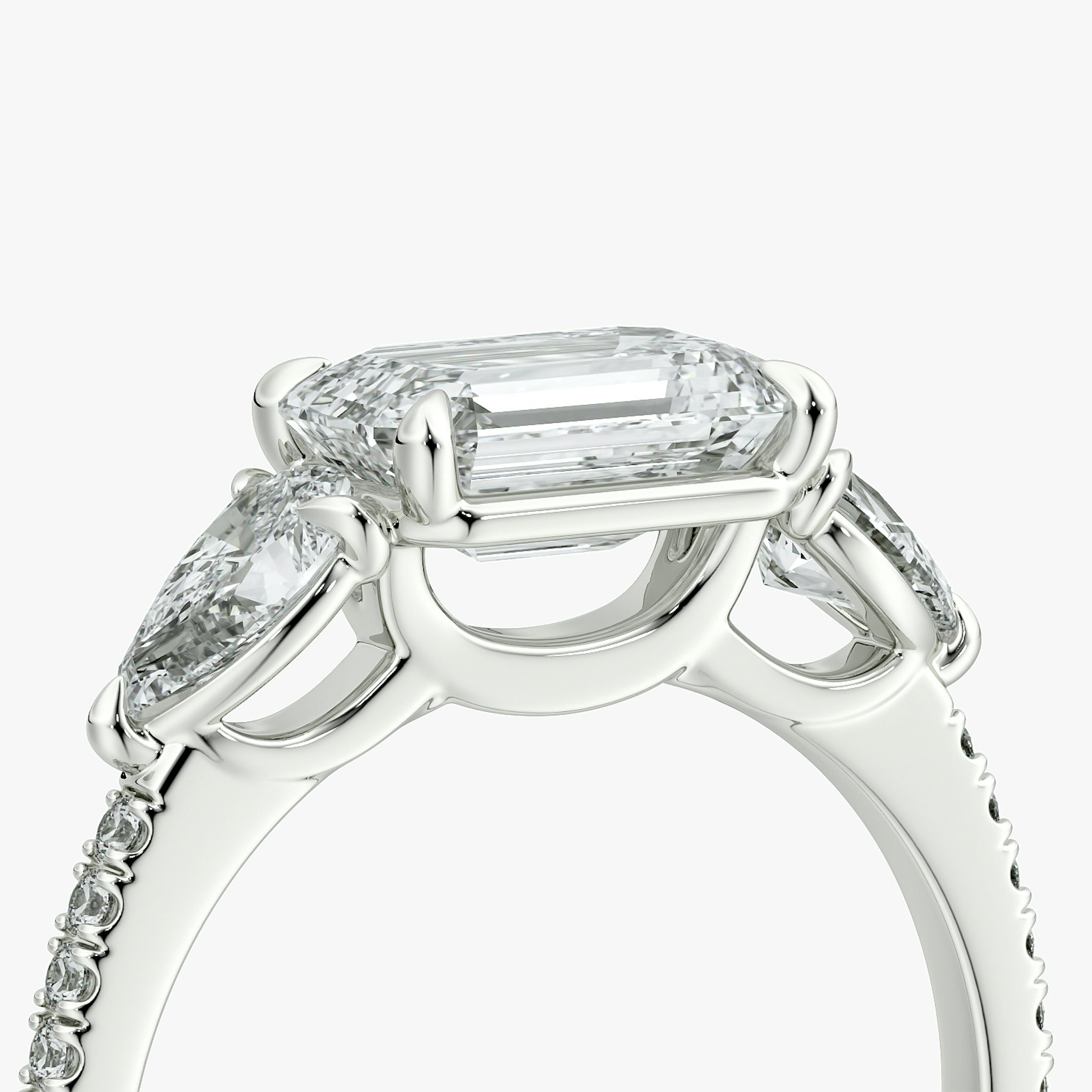 The Three Stone | Emerald | Platinum | bandAccent: Pavé | diamondOrientation: horizontal | sideStoneCarat: 0.25ct | sideStoneShape: Pear | caratWeight: other