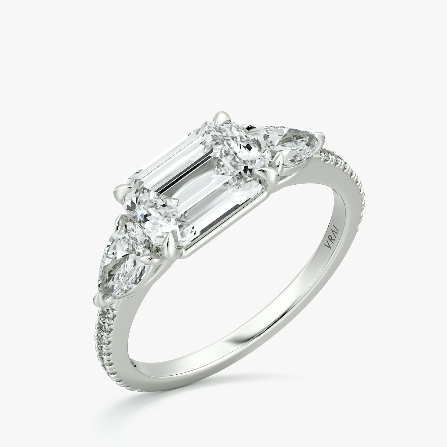 The Three Stone | Emerald | Platinum | bandAccent: Pavé | diamondOrientation: horizontal | sideStoneCarat: 0.25ct | sideStoneShape: Pear | caratWeight: other