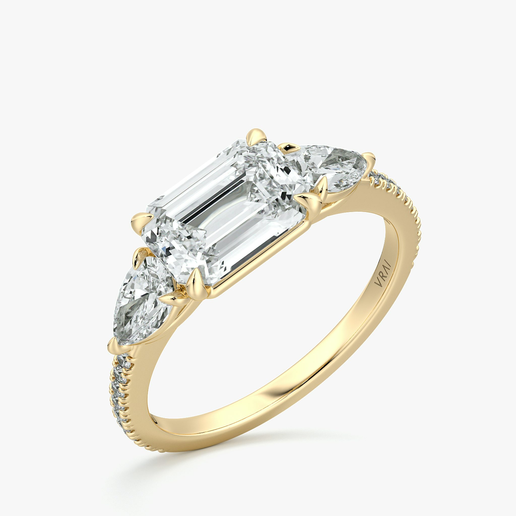 The Three Stone | Emerald | 18k | Yellow Gold | bandAccent: Pavé | diamondOrientation: horizontal | sideStoneCarat: 0.25ct | sideStoneShape: Pear | caratWeight: other