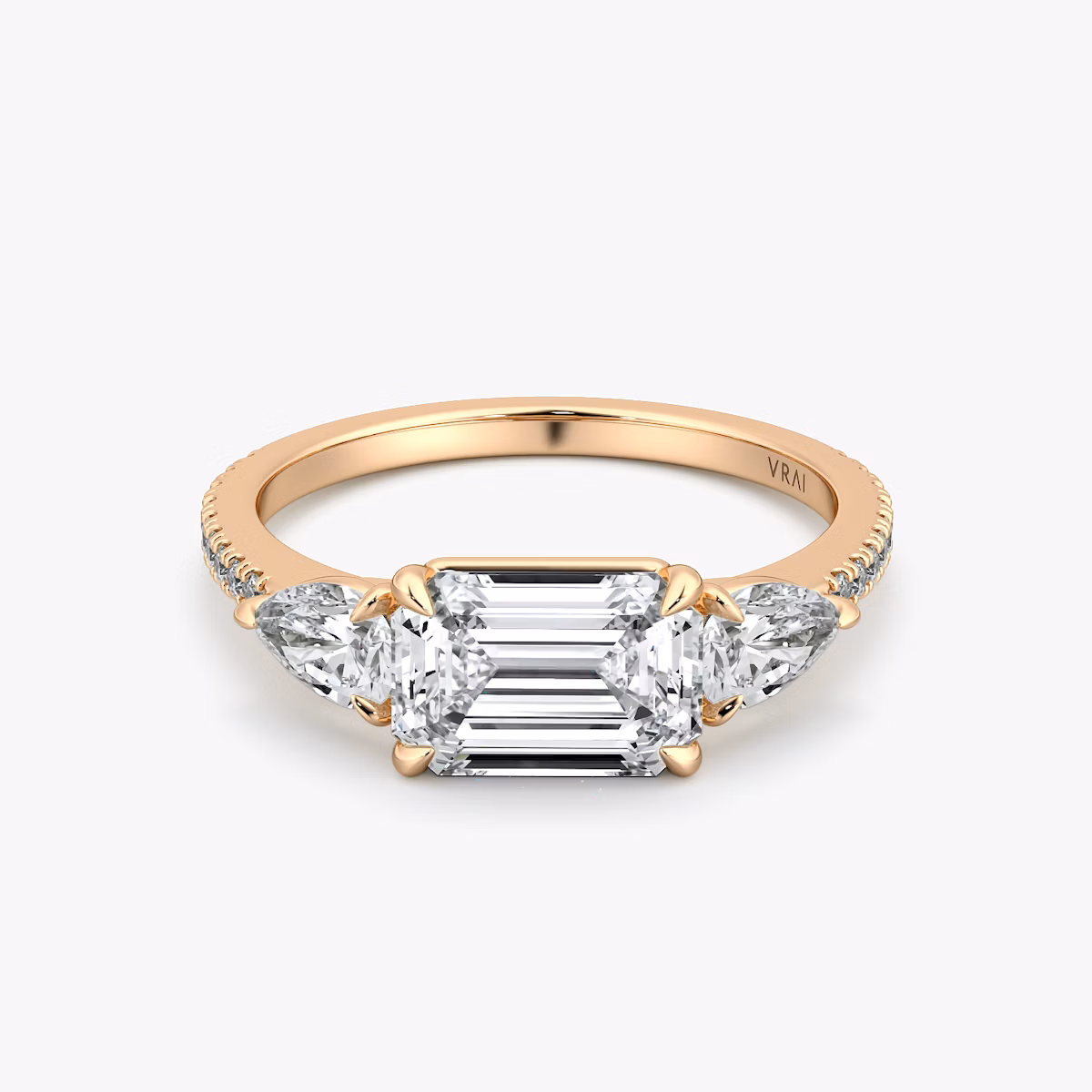 The Three Stone | Emerald | 14k | Rose Gold | bandAccent: Pavé | diamondOrientation: horizontal | sideStoneCarat: 0.25ct | sideStoneShape: Pear | caratWeight: other