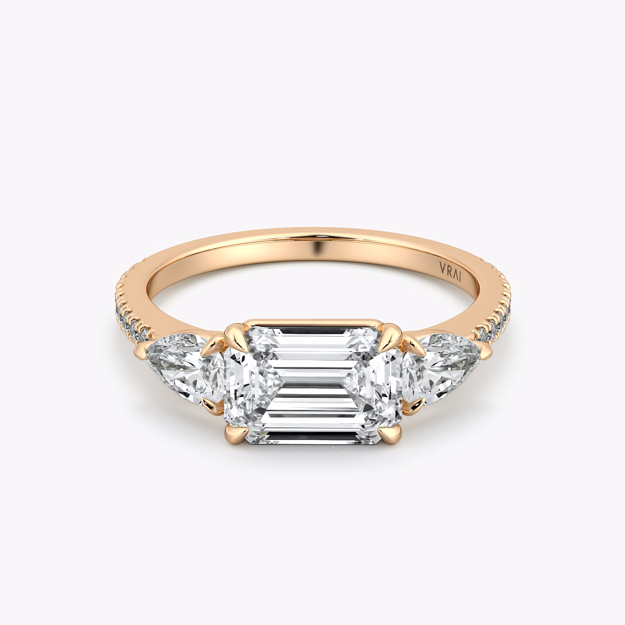 The Three Stone | Emerald | 14k | Rose Gold | bandAccent: Pavé | diamondOrientation: horizontal | sideStoneCarat: 0.25ct | sideStoneShape: Pear | caratWeight: other