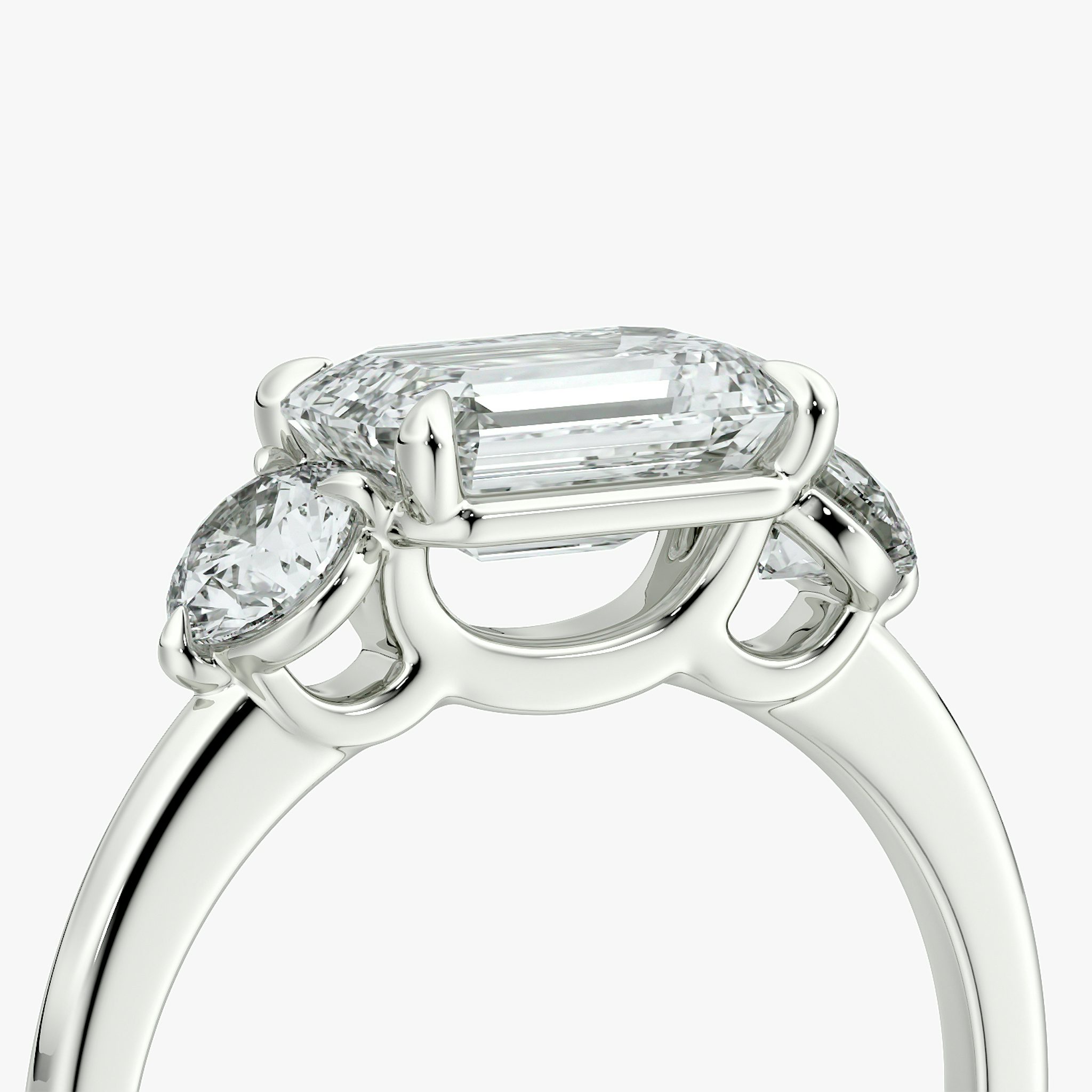 The Three Stone | Emerald | 18k | White Gold | bandAccent: Plain | diamondOrientation: horizontal | sideStoneCarat: 0.25ct | sideStoneShape: Round Brilliant | caratWeight: other