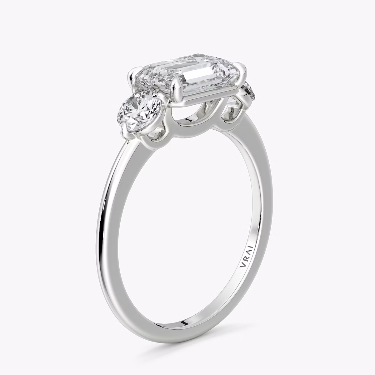 The Three Stone | Emerald | Platinum | bandAccent: Plain | diamondOrientation: horizontal | sideStoneCarat: 0.25ct | sideStoneShape: Round Brilliant | caratWeight: other