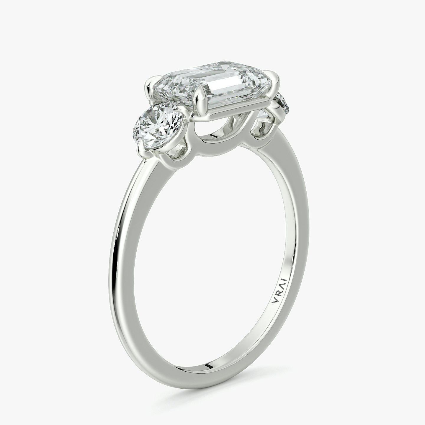 The Three Stone | Emerald | 18k | White Gold | bandAccent: Plain | diamondOrientation: horizontal | sideStoneCarat: 0.25ct | sideStoneShape: Round Brilliant | caratWeight: other