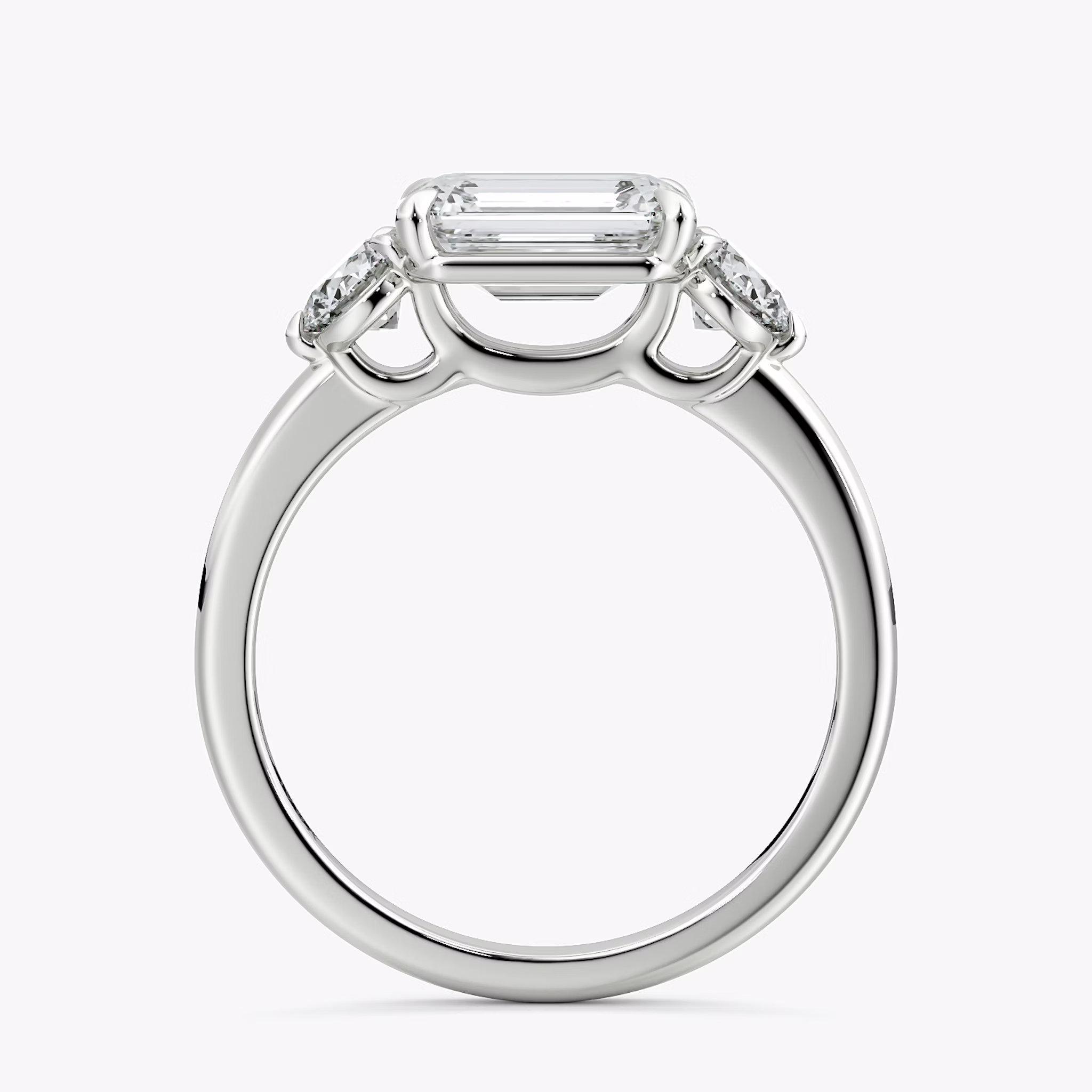 The Three Stone | Emerald | 18k | White Gold | bandAccent: Plain | diamondOrientation: horizontal | sideStoneCarat: 0.25ct | sideStoneShape: Round Brilliant | caratWeight: other