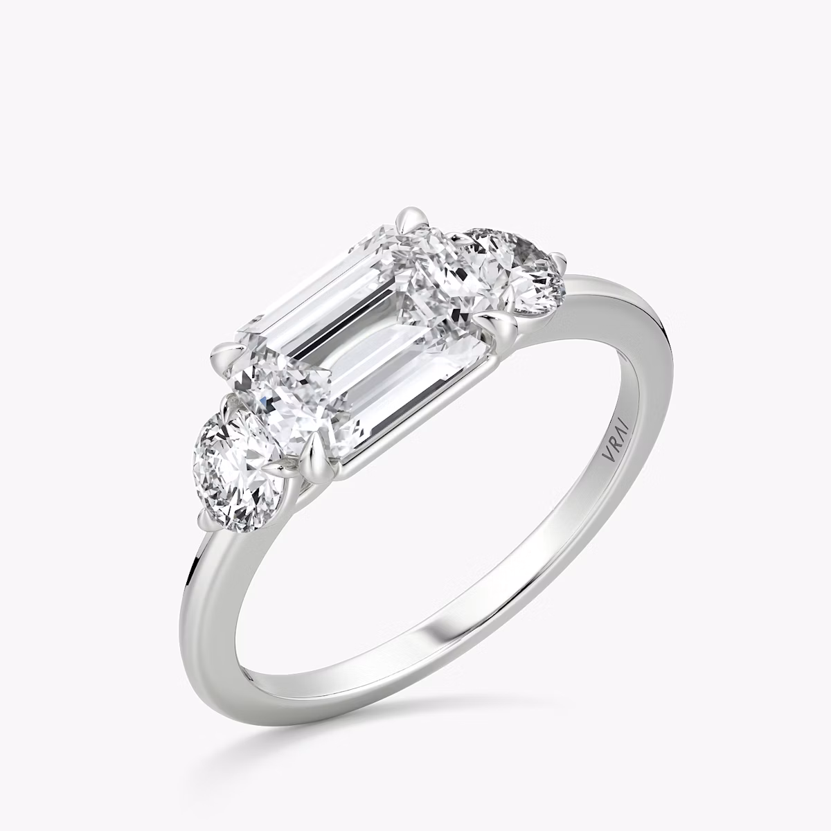 The Three Stone | Emerald | Platinum | bandAccent: Plain | diamondOrientation: horizontal | sideStoneCarat: 0.25ct | sideStoneShape: Round Brilliant | caratWeight: other