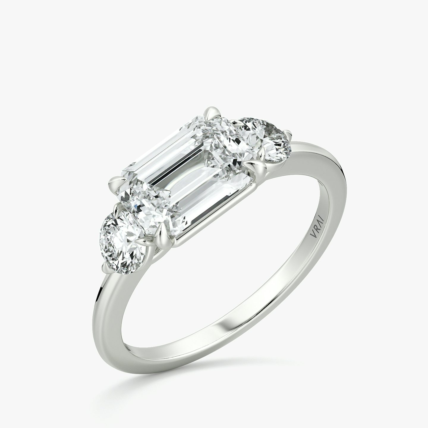 The Three Stone | Emerald | 18k | White Gold | bandAccent: Plain | diamondOrientation: horizontal | sideStoneCarat: 0.25ct | sideStoneShape: Round Brilliant | caratWeight: other