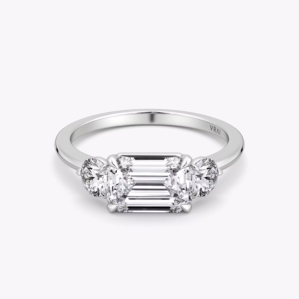 The Three Stone | Emerald | Platinum | bandAccent: Plain | diamondOrientation: horizontal | sideStoneCarat: 0.25ct | sideStoneShape: Round Brilliant | caratWeight: other