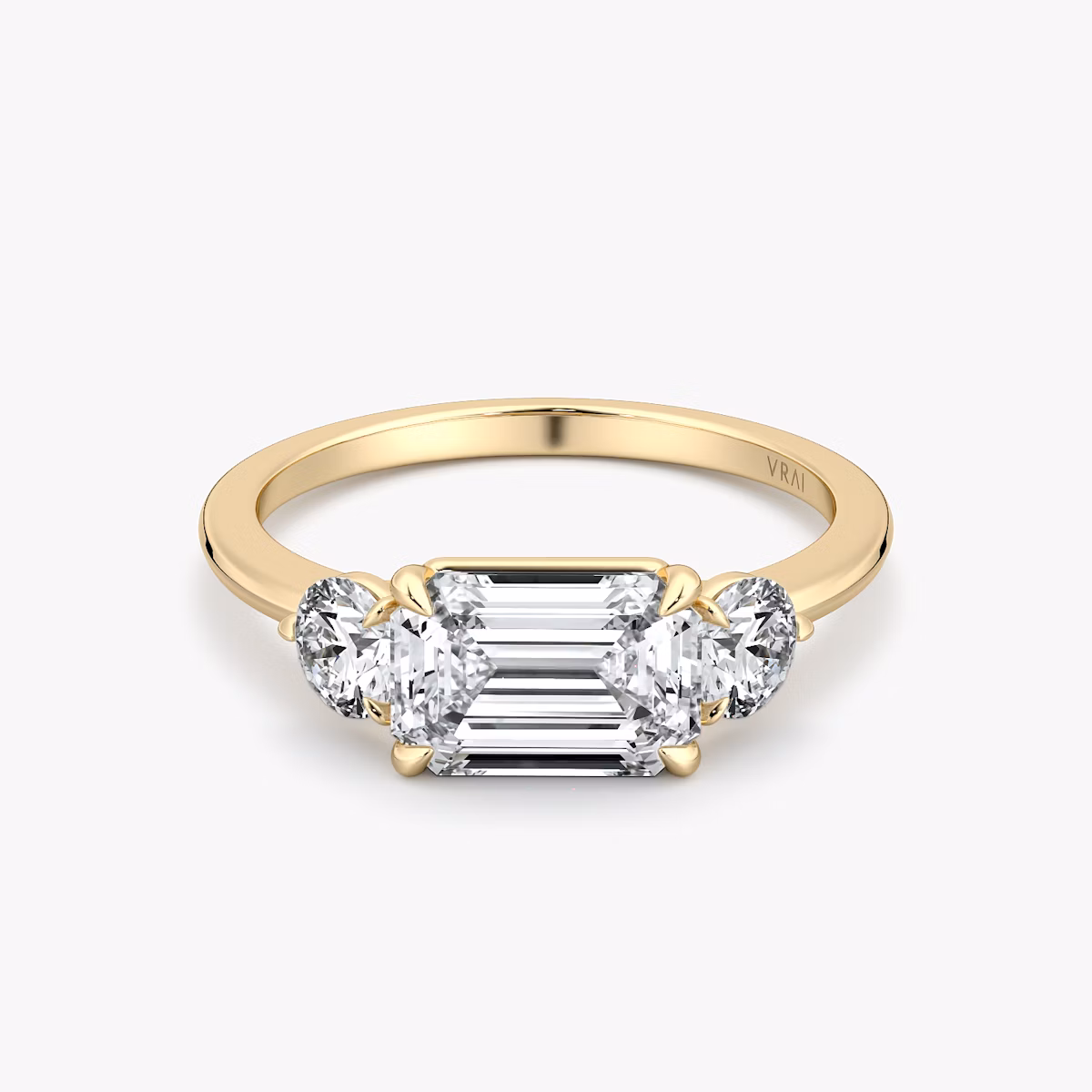 The Three Stone | Emerald | 18k | Yellow Gold | bandAccent: Plain | diamondOrientation: horizontal | sideStoneCarat: 0.25ct | sideStoneShape: Round Brilliant | caratWeight: other