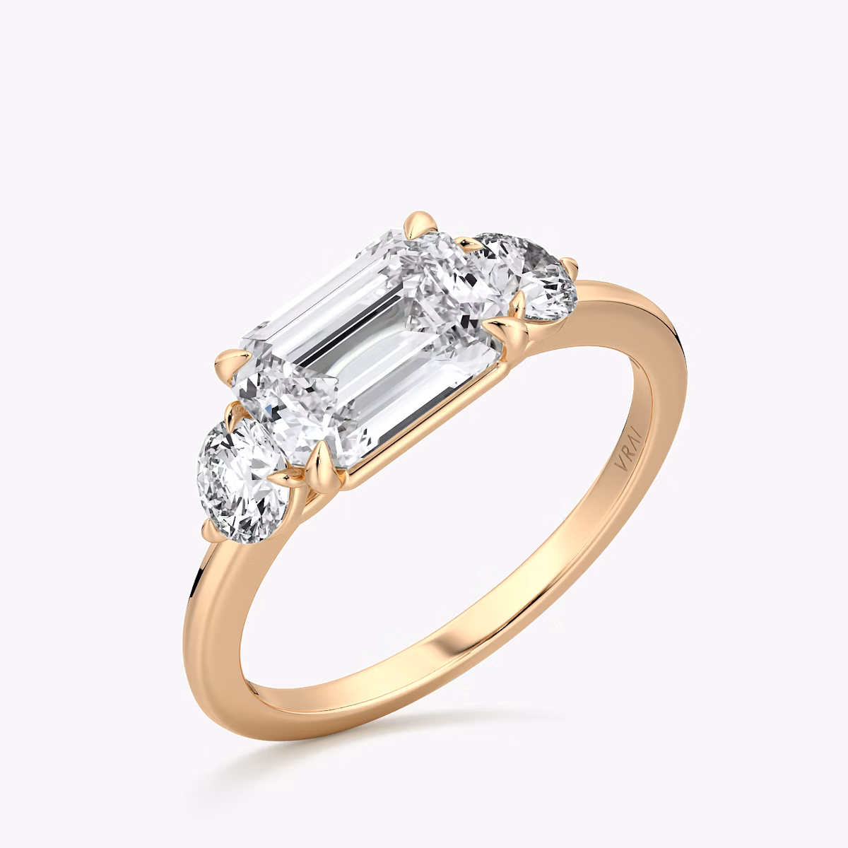 The Three Stone | Emerald | 14k | Rose Gold | bandAccent: Plain | diamondOrientation: horizontal | sideStoneCarat: 0.25ct | sideStoneShape: Round Brilliant | caratWeight: other