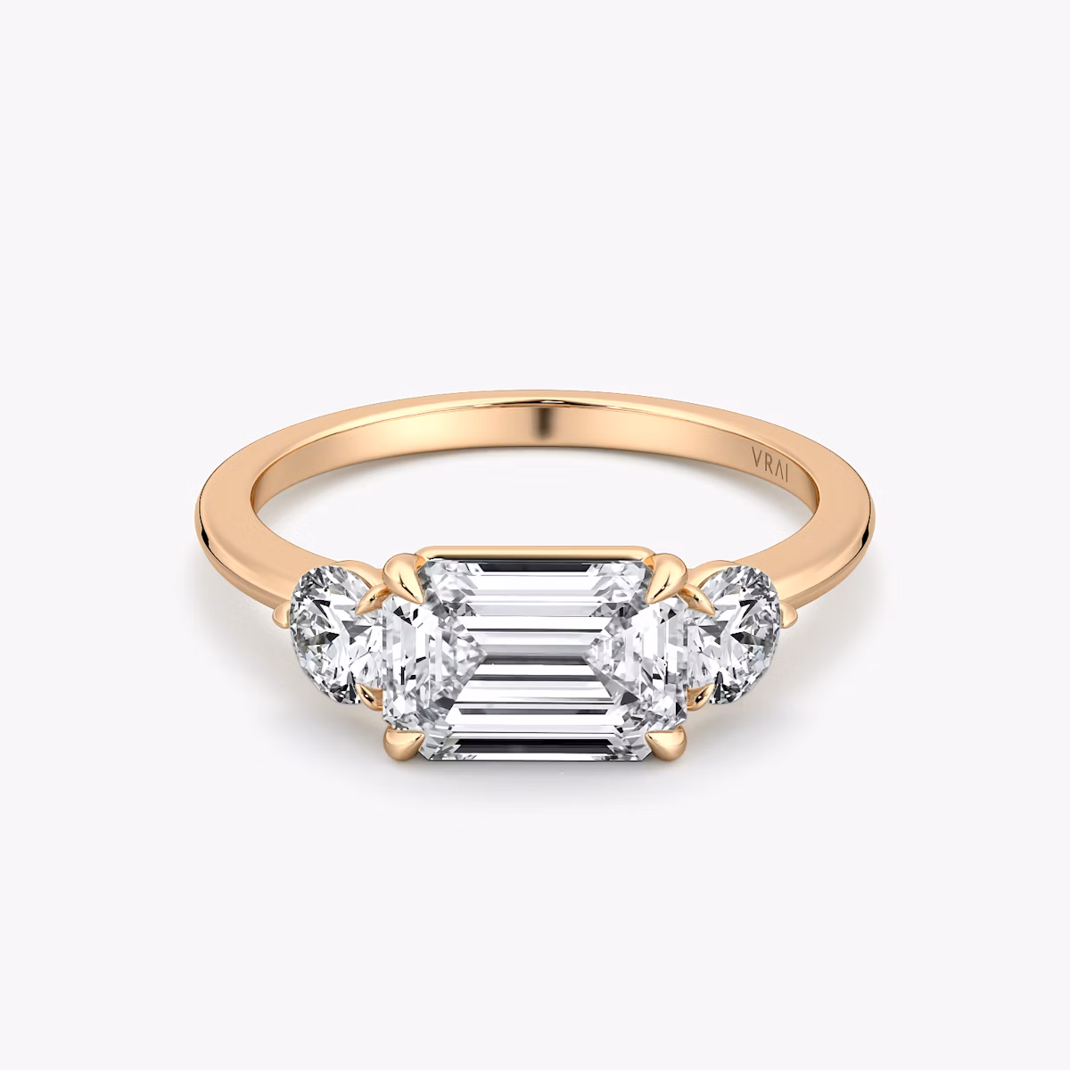 The Three Stone | Emerald | 14k | Rose Gold | bandAccent: Plain | diamondOrientation: horizontal | sideStoneCarat: 0.25ct | sideStoneShape: Round Brilliant | caratWeight: other