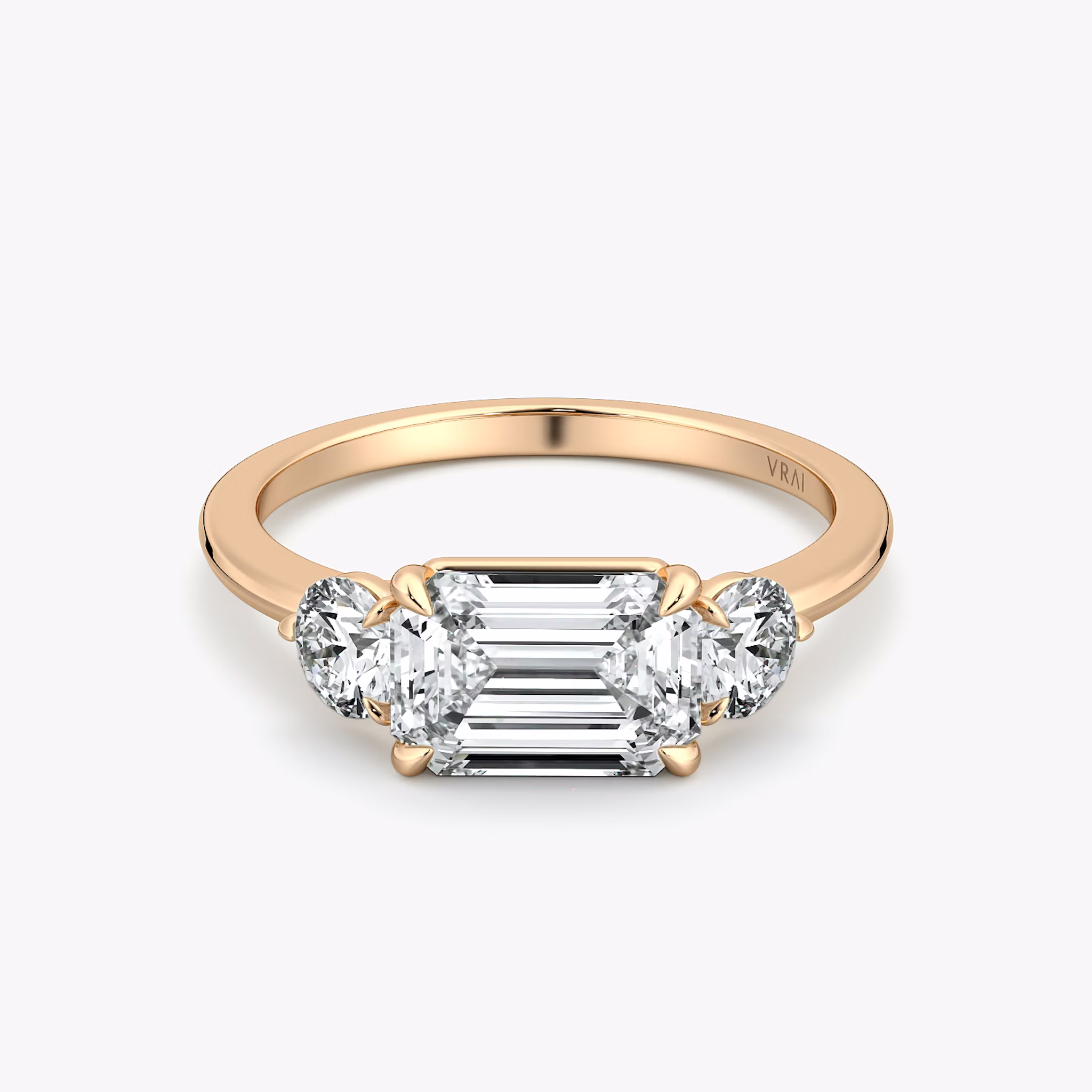 The Three Stone | Emerald | 14k | Rose Gold | bandAccent: Plain | diamondOrientation: horizontal | sideStoneCarat: 0.25ct | sideStoneShape: Round Brilliant | caratWeight: other