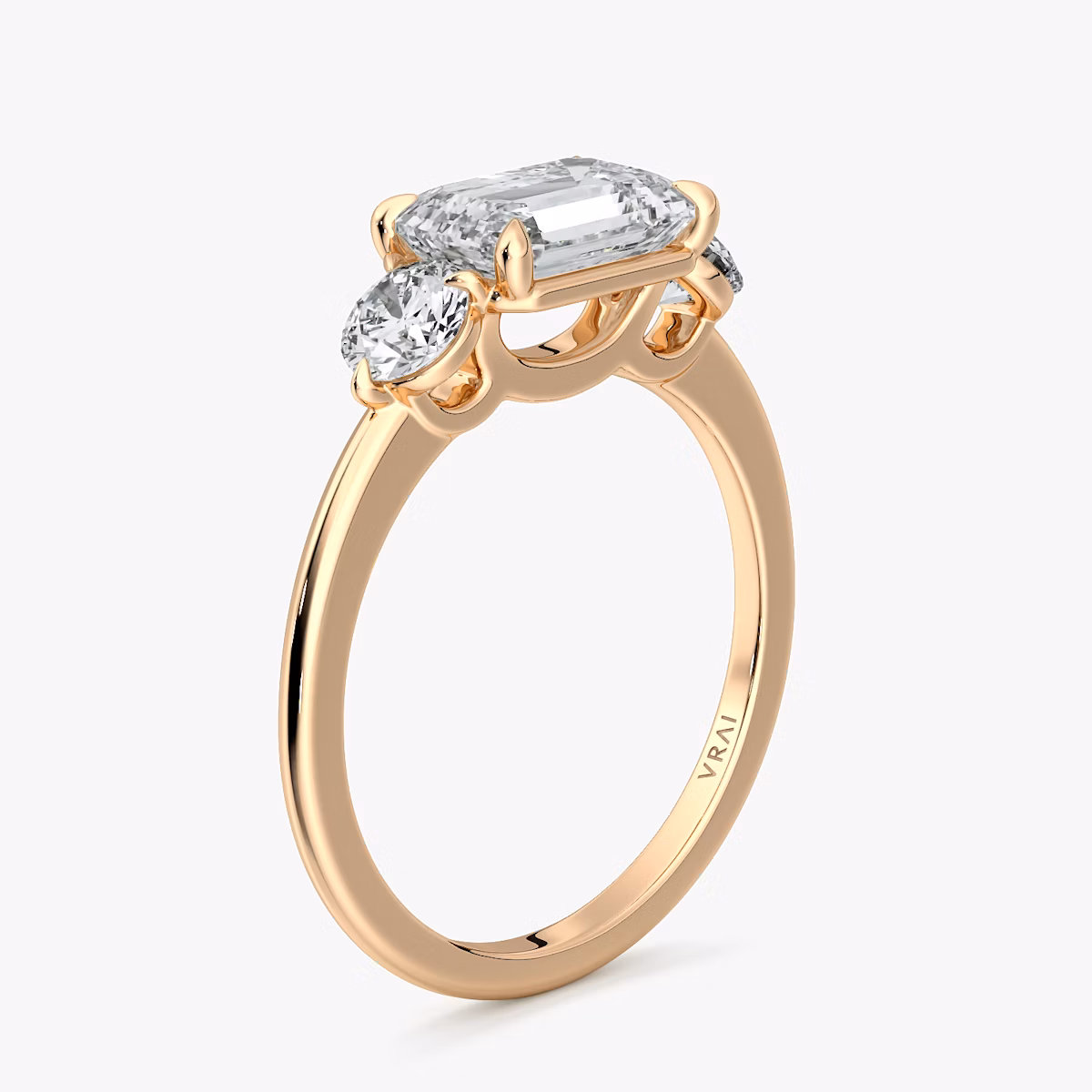 The Three Stone | Emerald | 14k | Rose Gold | bandAccent: Plain | diamondOrientation: horizontal | sideStoneCarat: 0.25ct | sideStoneShape: Round Brilliant | caratWeight: other