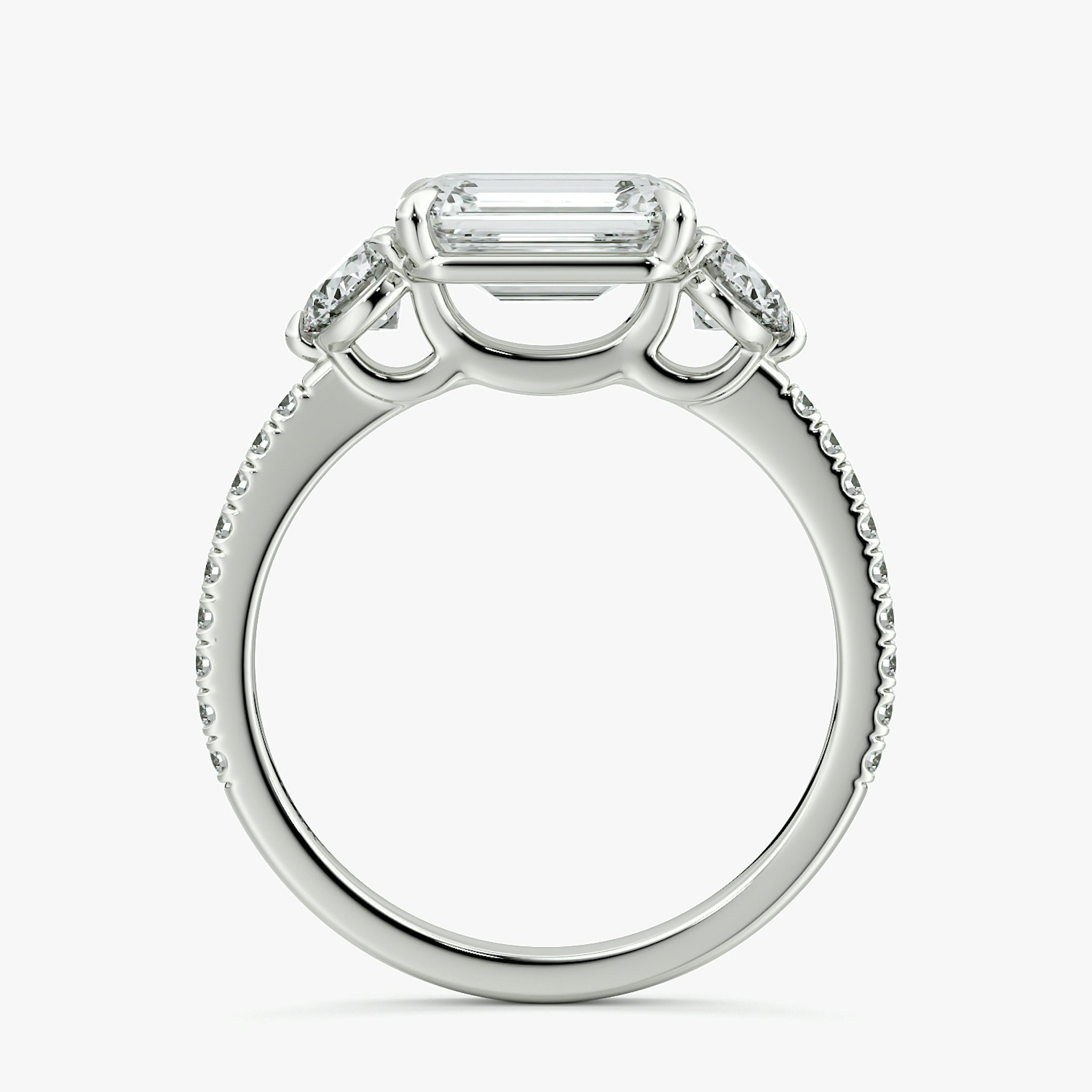 The Three Stone | Emerald | Platinum | bandAccent: Pavé | diamondOrientation: horizontal | sideStoneCarat: 0.25ct | sideStoneShape: Round Brilliant | caratWeight: other