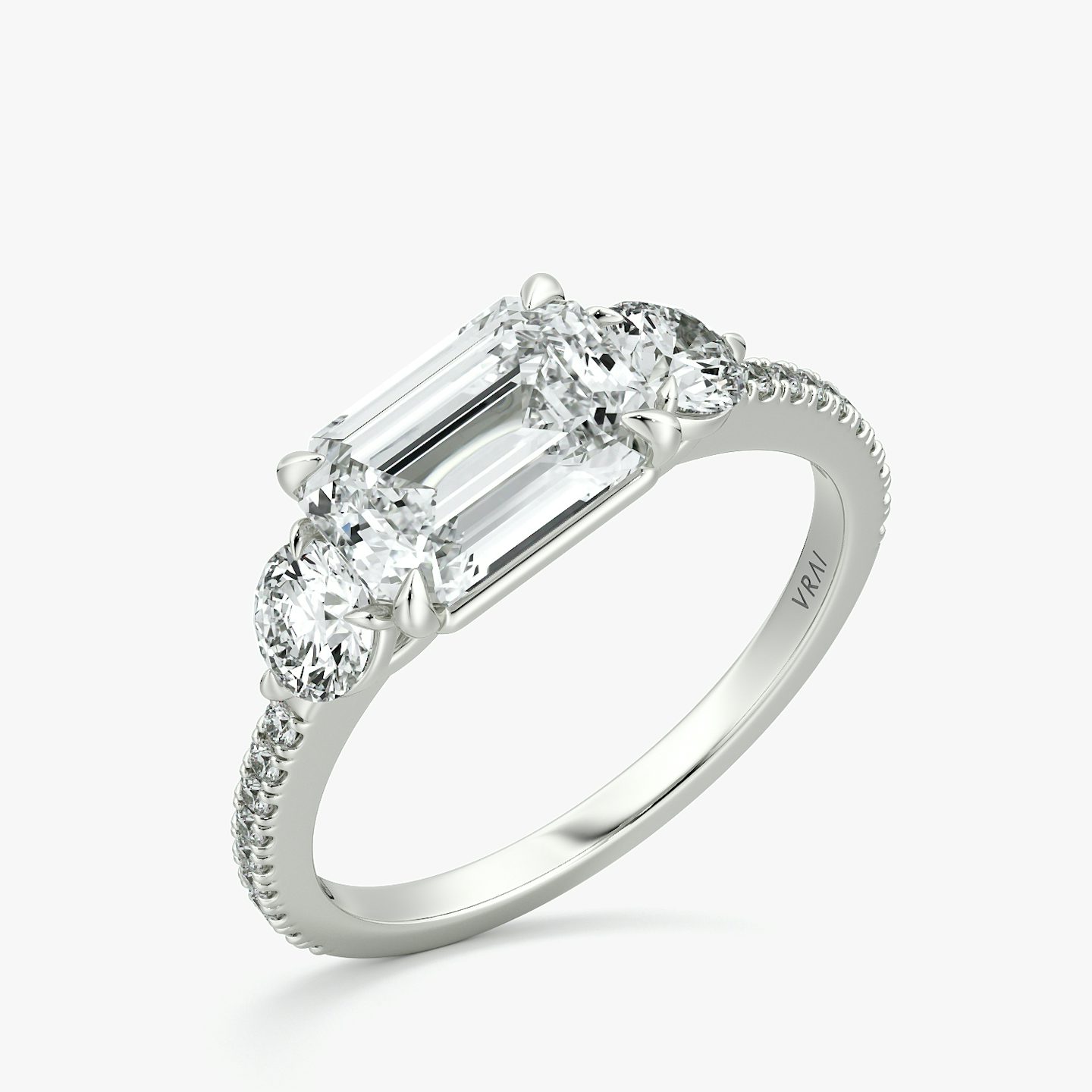 The Three Stone | Emerald | 18k | White Gold | bandAccent: Pavé | diamondOrientation: horizontal | sideStoneCarat: 0.25ct | sideStoneShape: Round Brilliant | caratWeight: other