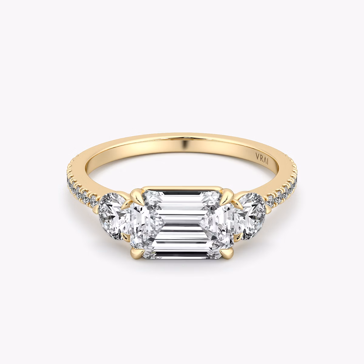 The Three Stone | Emerald | 18k | Yellow Gold | bandAccent: Pavé | diamondOrientation: horizontal | sideStoneCarat: 0.25ct | sideStoneShape: Round Brilliant | caratWeight: other