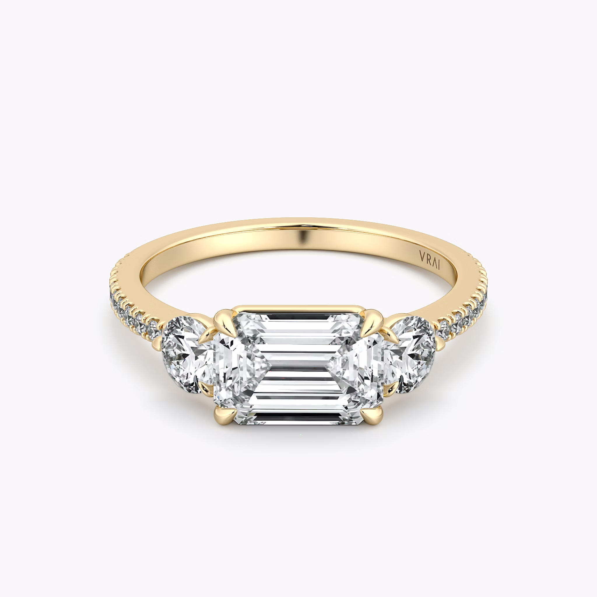 The Three Stone | Emerald | 18k | Yellow Gold | bandAccent: Pavé | diamondOrientation: horizontal | sideStoneCarat: 0.25ct | sideStoneShape: Round Brilliant | caratWeight: other