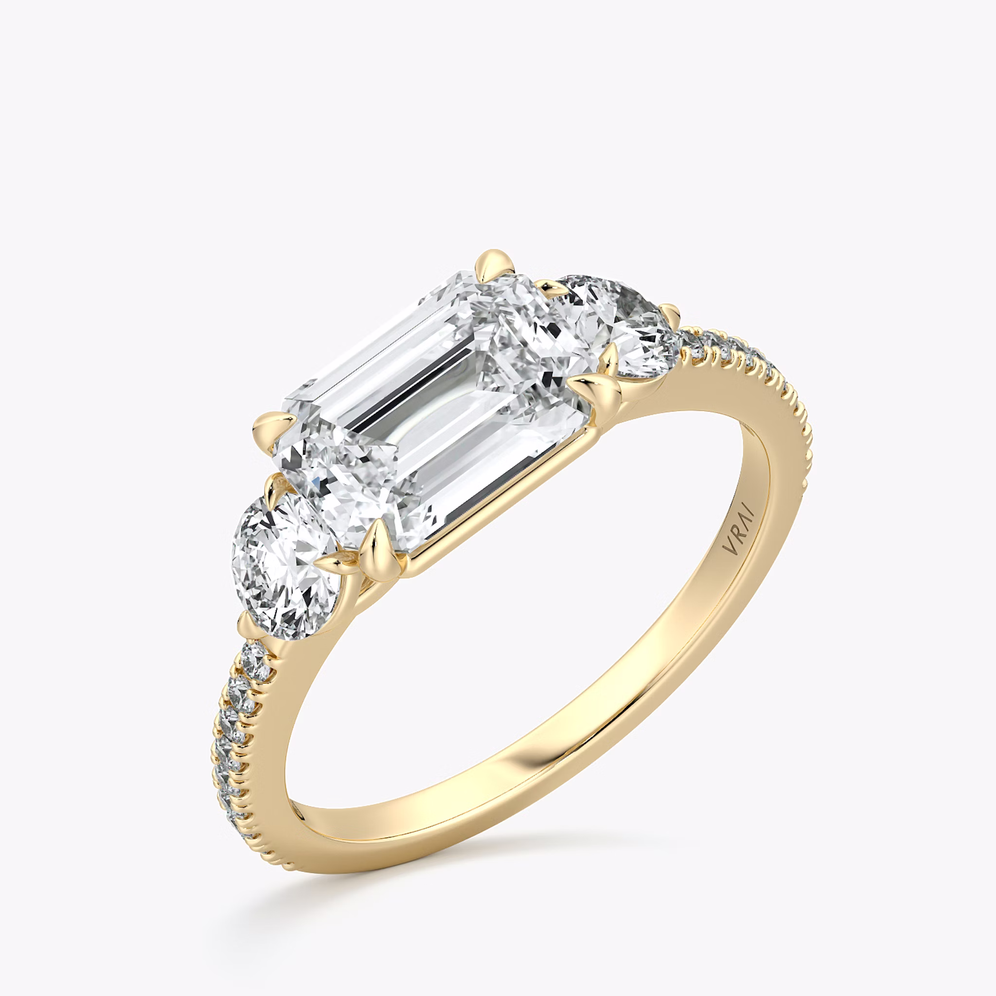 The Three Stone | Emerald | 18k | Yellow Gold | bandAccent: Pavé | diamondOrientation: horizontal | sideStoneCarat: 0.25ct | sideStoneShape: Round Brilliant | caratWeight: other