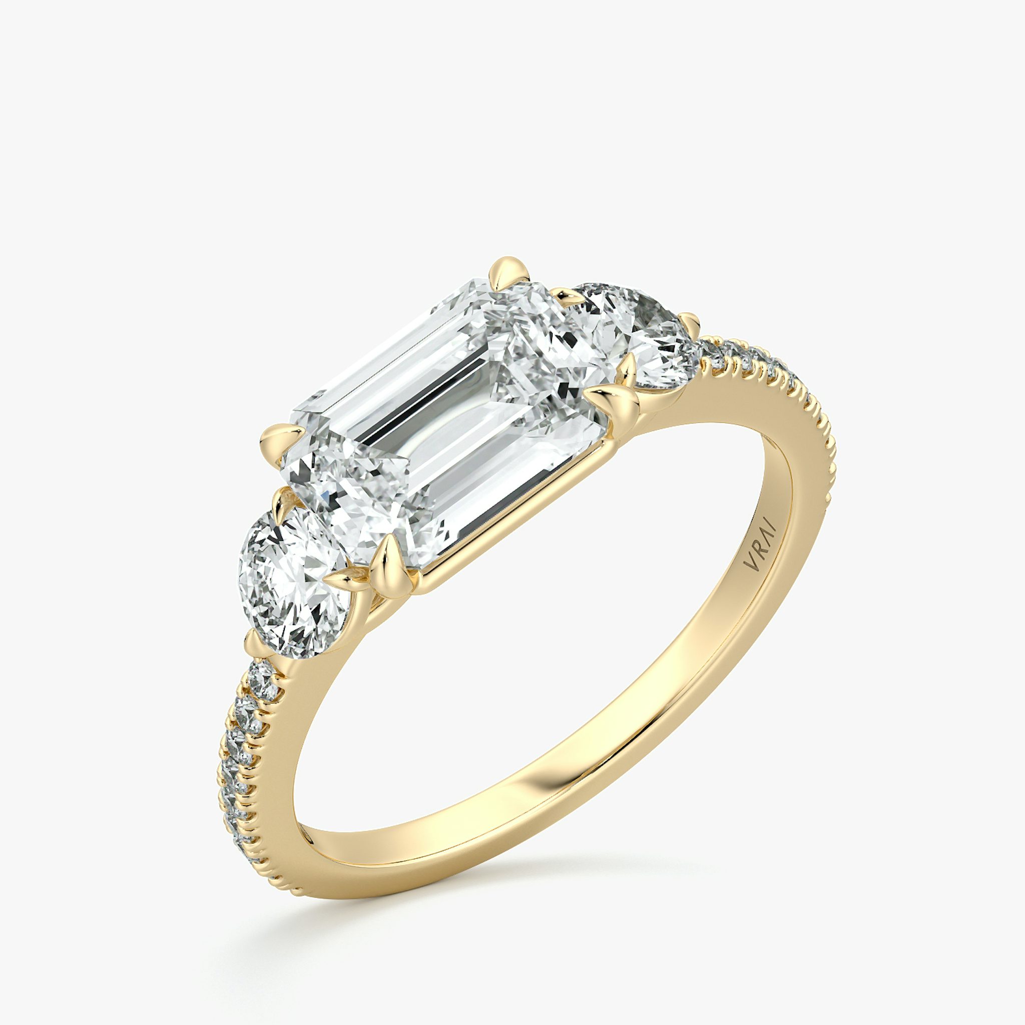 The Three Stone | Emerald | 18k | Yellow Gold | bandAccent: Pavé | diamondOrientation: horizontal | sideStoneCarat: 0.25ct | sideStoneShape: Round Brilliant | caratWeight: other