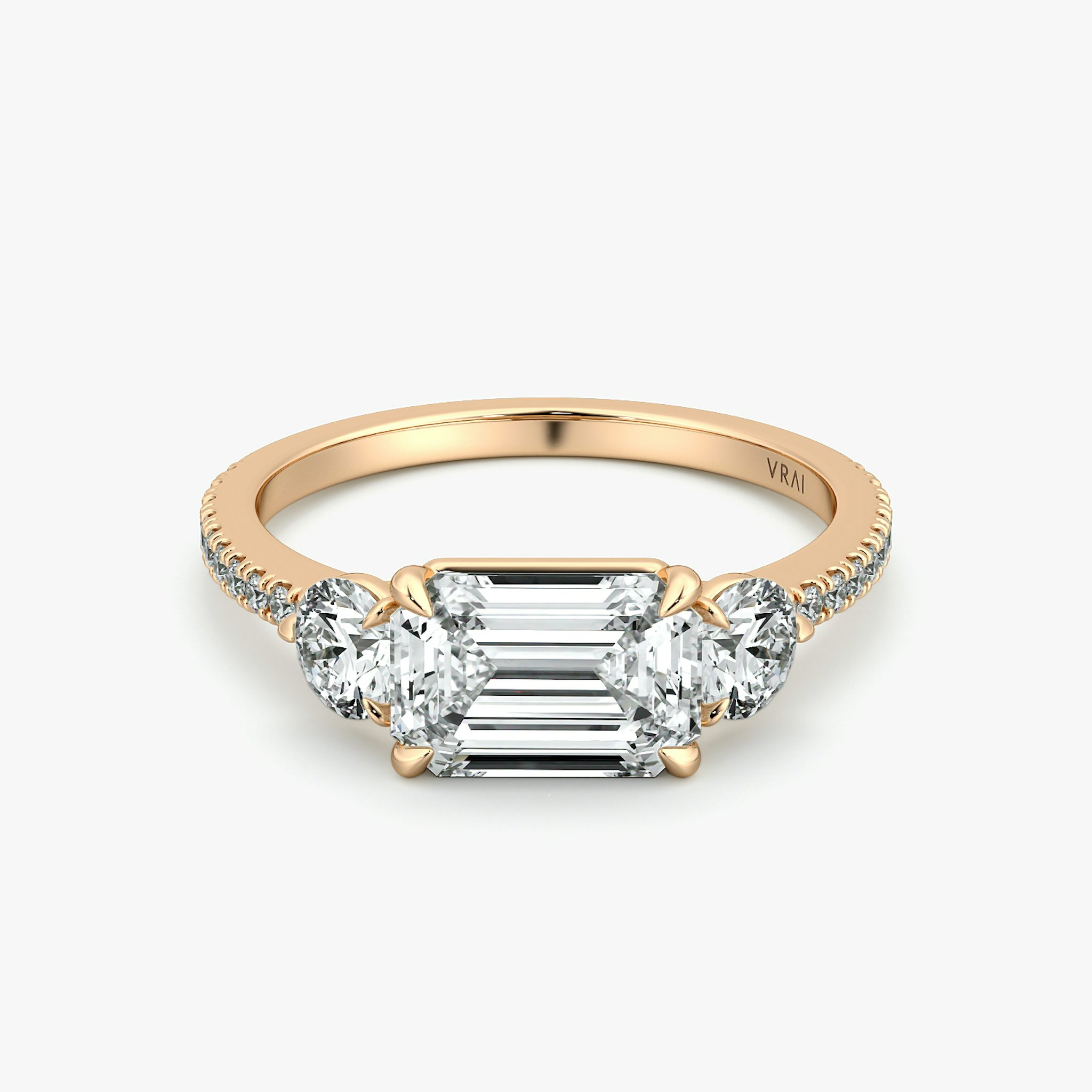 The Three Stone | Emerald | 14k | Rose Gold | bandAccent: Pavé | diamondOrientation: horizontal | sideStoneCarat: 0.25ct | sideStoneShape: Round Brilliant | caratWeight: other