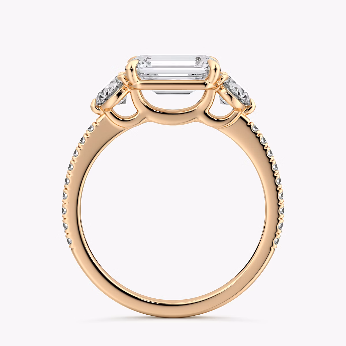 The Three Stone | Emerald | 14k | Rose Gold | bandAccent: Pavé | diamondOrientation: horizontal | sideStoneCarat: 0.25ct | sideStoneShape: Round Brilliant | caratWeight: other