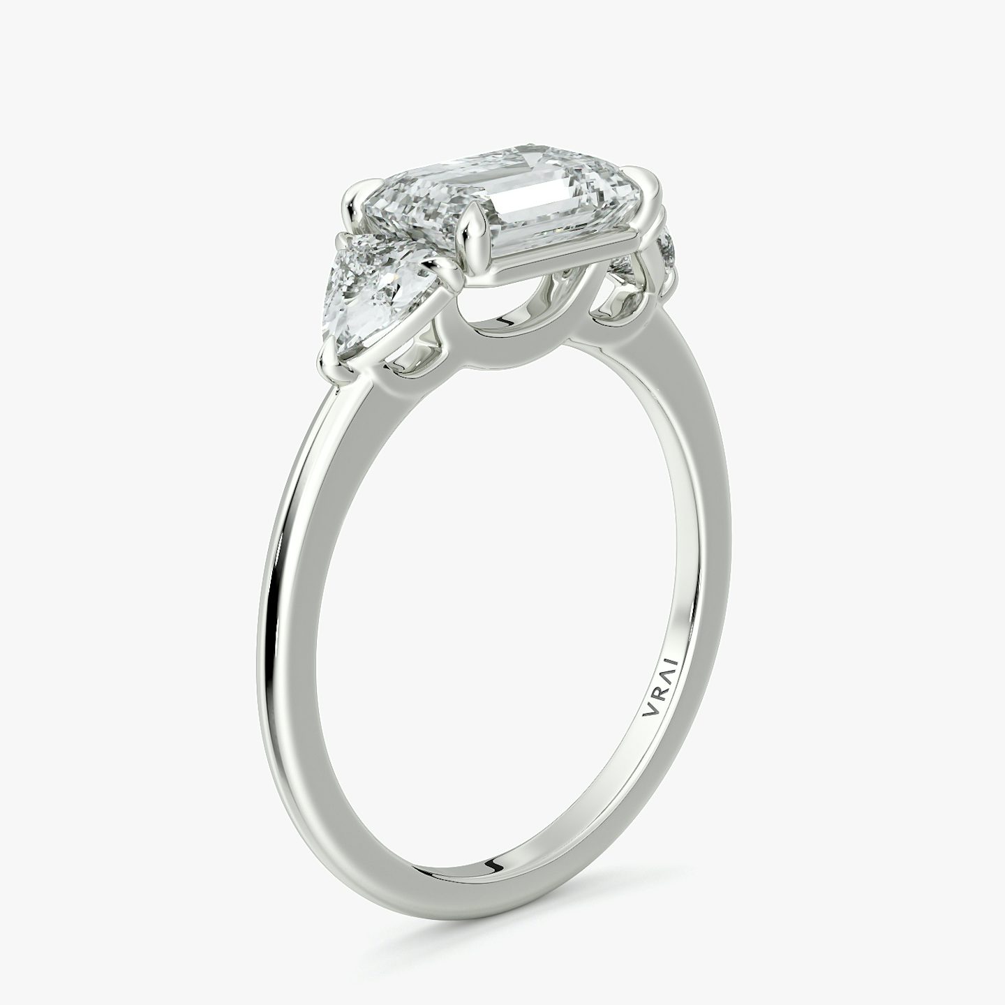 The Three Stone | Emerald | Platinum | bandAccent: Plain | diamondOrientation: horizontal | sideStoneCarat: 0.25ct | sideStoneShape: Trillion | caratWeight: other