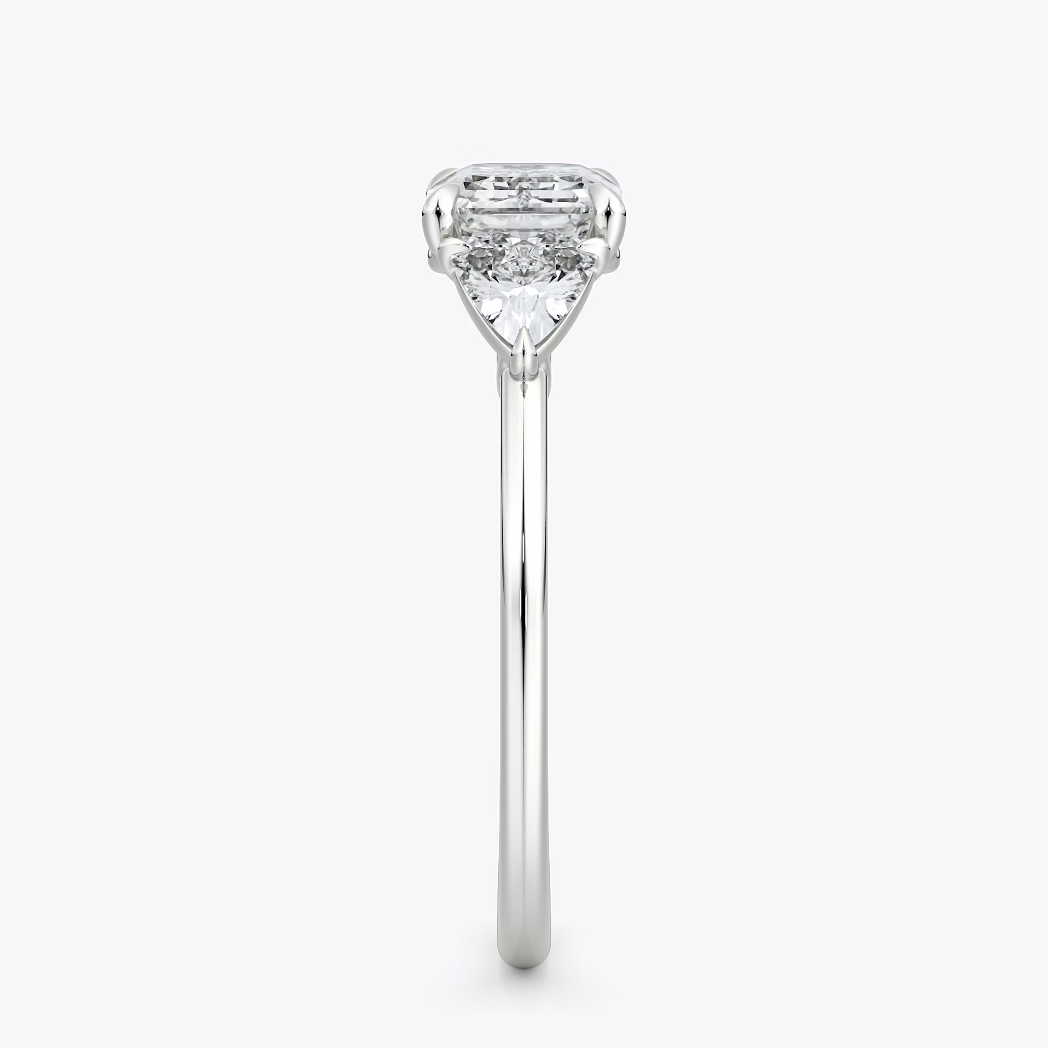 The Three Stone | Emerald | 18k | White Gold | bandAccent: Plain | diamondOrientation: horizontal | sideStoneCarat: 0.25ct | sideStoneShape: Trillion | caratWeight: other