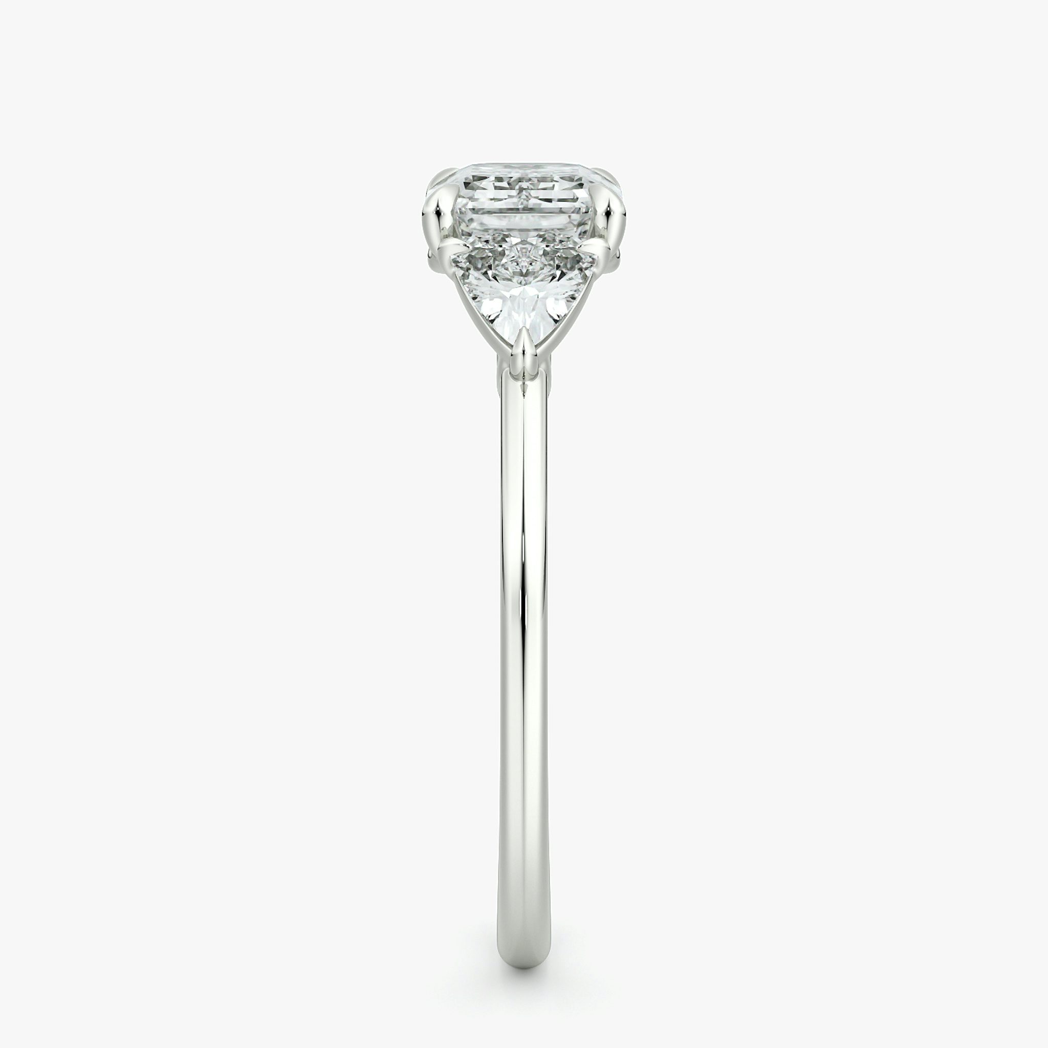 The Three Stone | Emerald | 18k | White Gold | bandAccent: Plain | diamondOrientation: horizontal | sideStoneCarat: 0.25ct | sideStoneShape: Trillion | caratWeight: other