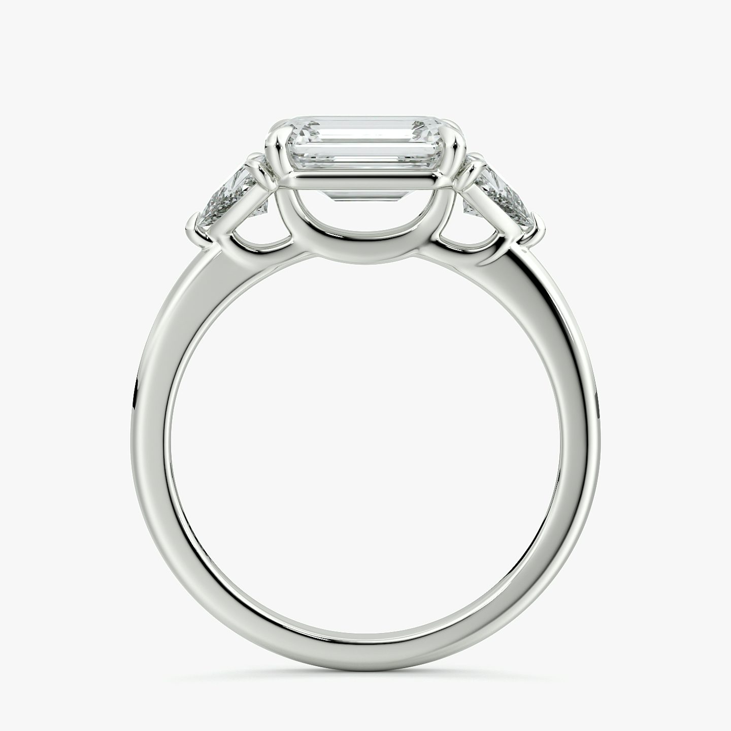 The Three Stone | Emerald | Platinum | bandAccent: Plain | diamondOrientation: horizontal | sideStoneCarat: 0.25ct | sideStoneShape: Trillion | caratWeight: other