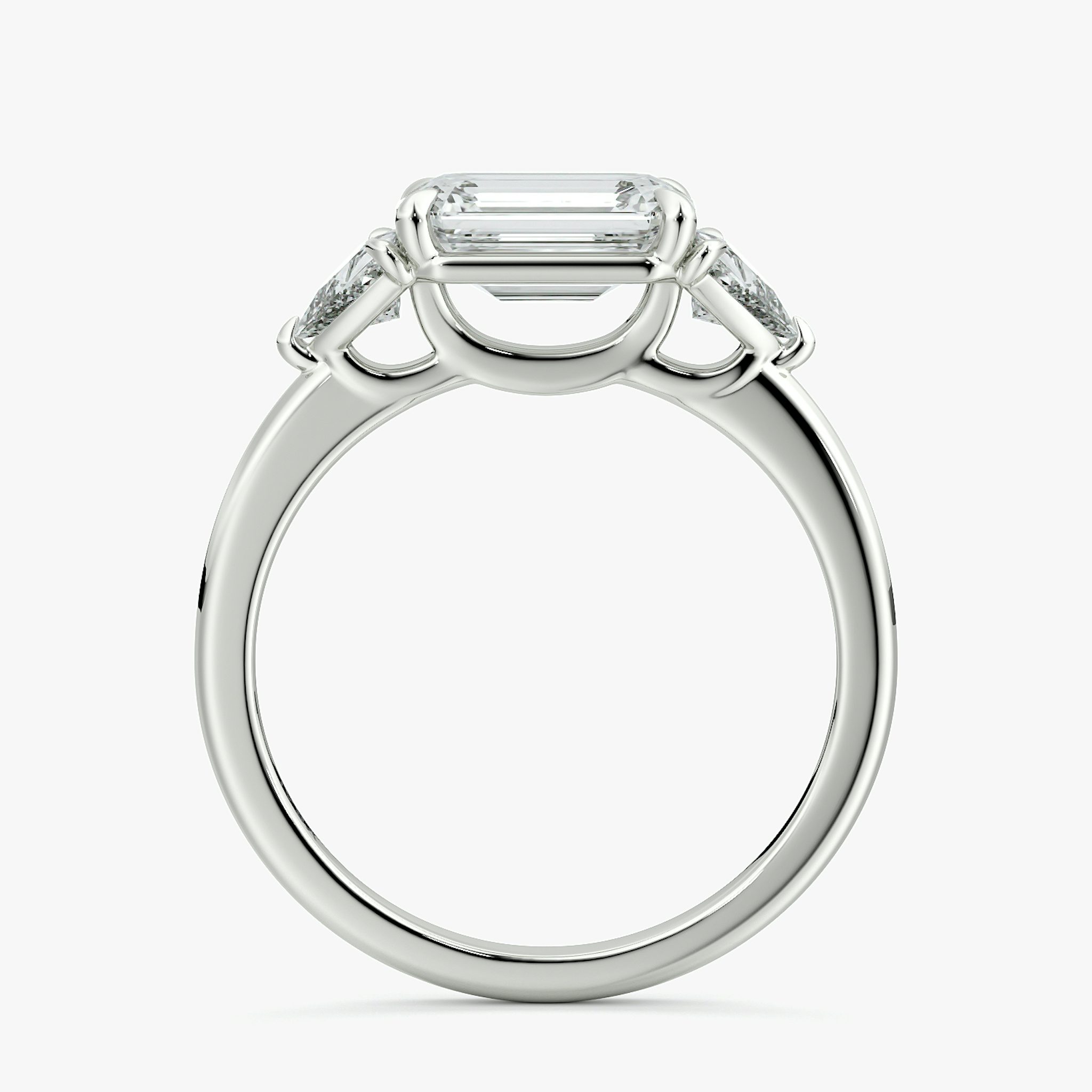 The Three Stone | Emerald | 18k | White Gold | bandAccent: Plain | diamondOrientation: horizontal | sideStoneCarat: 0.25ct | sideStoneShape: Trillion | caratWeight: other