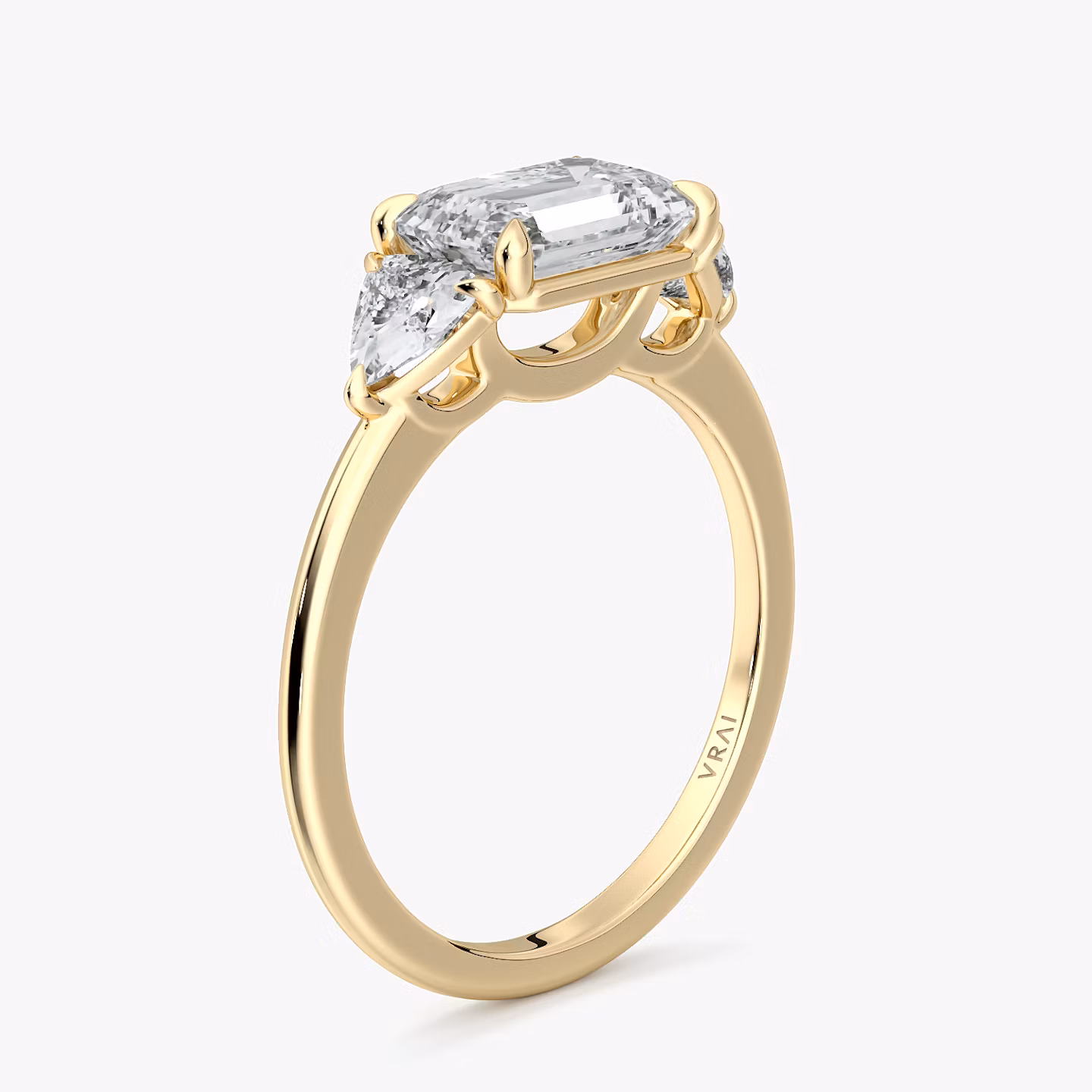 The Three Stone | Emerald | 18k | Yellow Gold | bandAccent: Plain | diamondOrientation: horizontal | sideStoneCarat: 0.25ct | sideStoneShape: Trillion | caratWeight: other