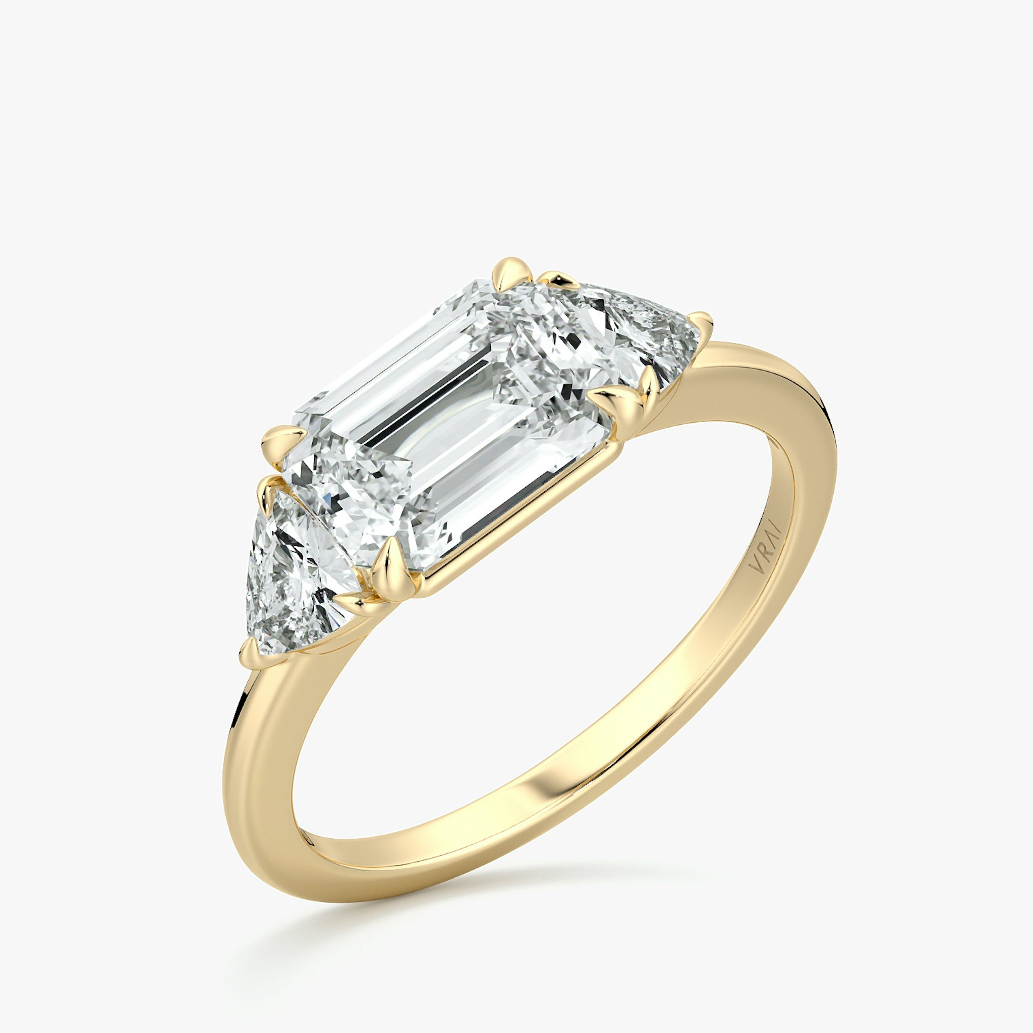The Three Stone | Emerald | 18k | Yellow Gold | bandAccent: Plain | diamondOrientation: horizontal | sideStoneCarat: 0.25ct | sideStoneShape: Trillion | caratWeight: other