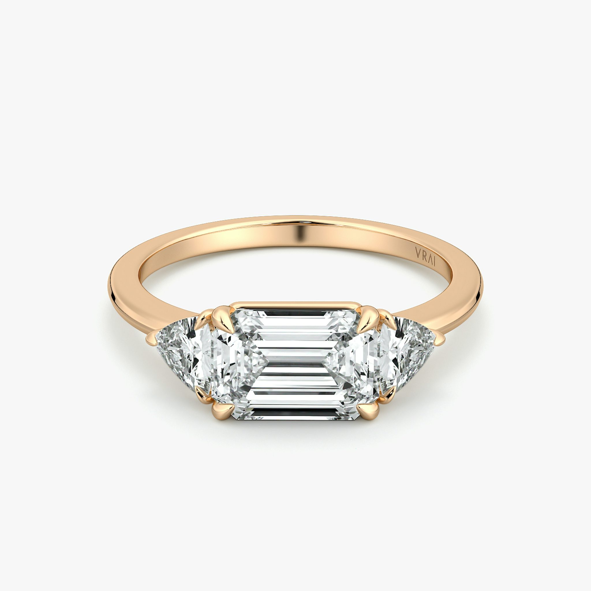 The Three Stone | Emerald | 14k | Rose Gold | bandAccent: Plain | diamondOrientation: horizontal | sideStoneCarat: 0.25ct | sideStoneShape: Trillion | caratWeight: other