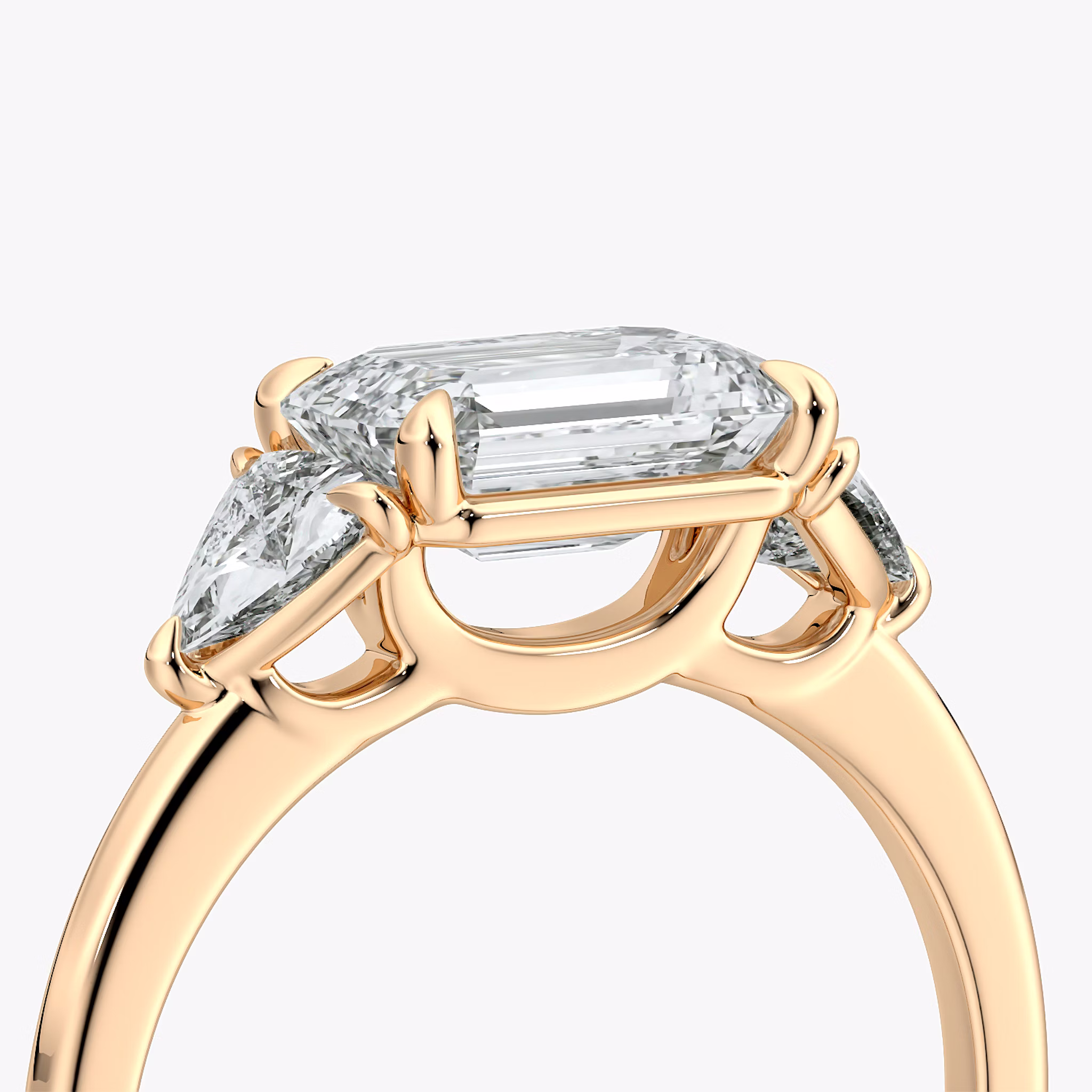 The Three Stone | Emerald | 14k | Rose Gold | bandAccent: Plain | diamondOrientation: horizontal | sideStoneCarat: 0.25ct | sideStoneShape: Trillion | caratWeight: other