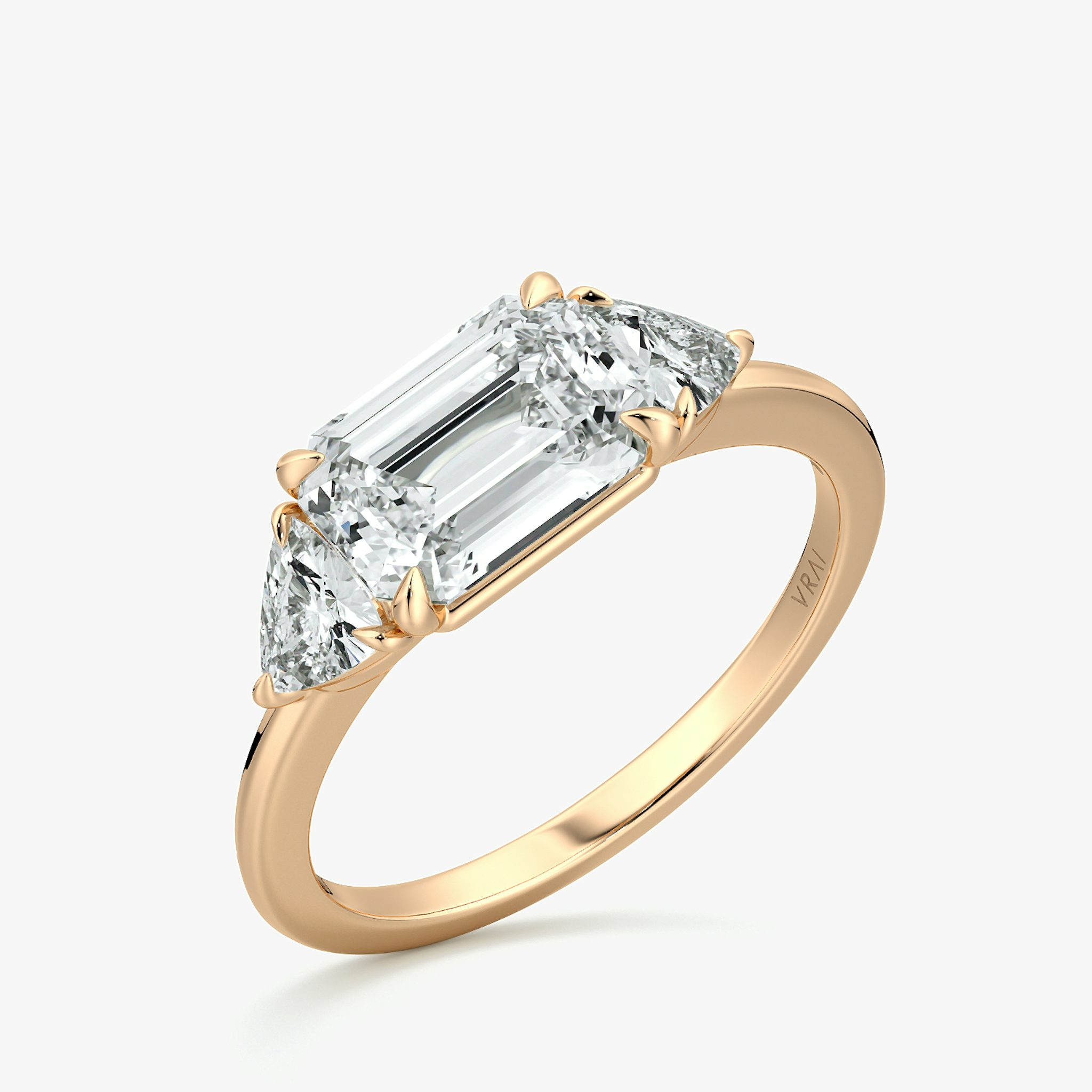 The Three Stone | Emerald | 14k | Rose Gold | bandAccent: Plain | diamondOrientation: horizontal | sideStoneCarat: 0.25ct | sideStoneShape: Trillion | caratWeight: other
