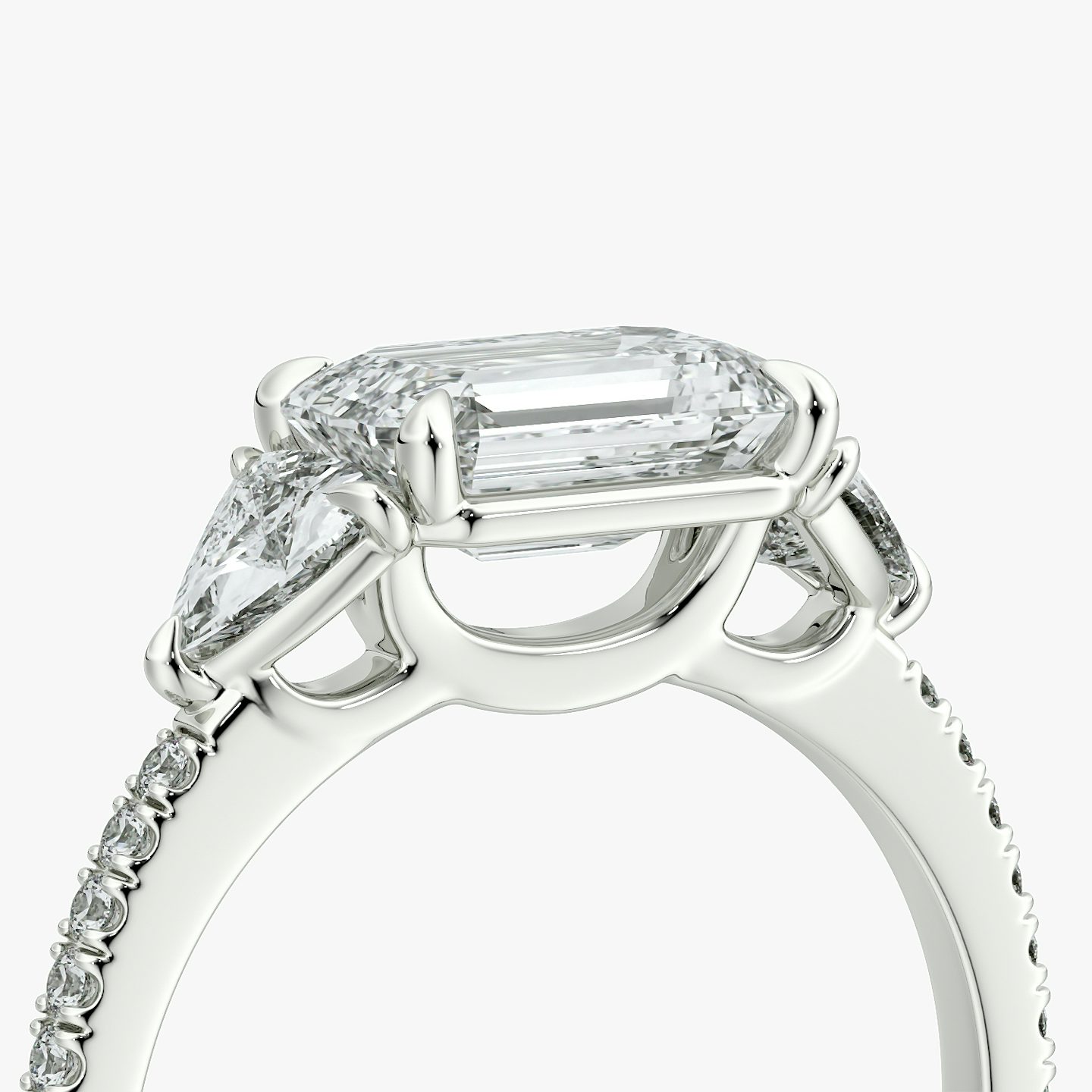 The Three Stone | Emerald | 18k | White Gold | bandAccent: Pavé | diamondOrientation: horizontal | sideStoneCarat: 0.25ct | sideStoneShape: Trillion | caratWeight: other