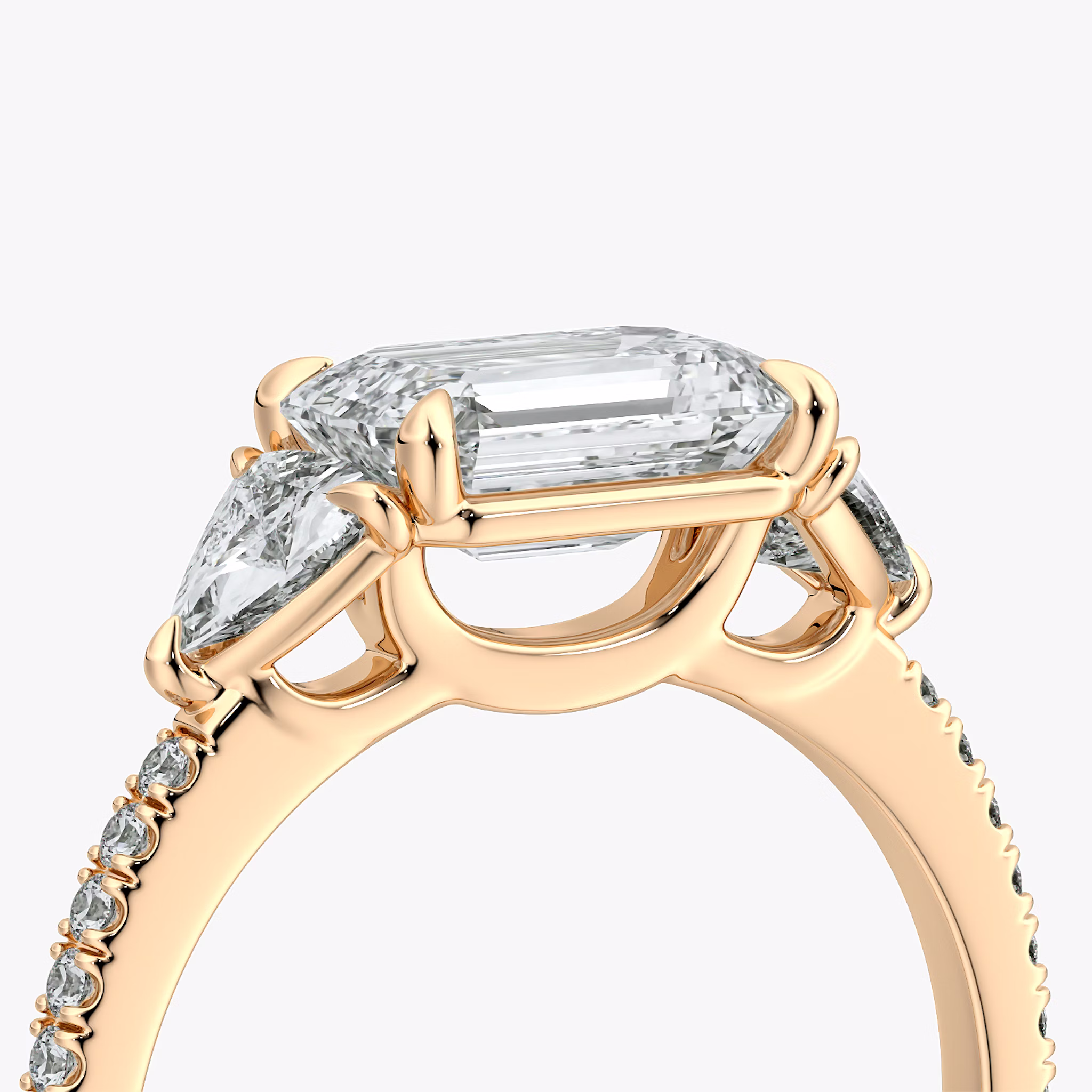 The Three Stone | Emerald | 14k | Rose Gold | bandAccent: Pavé | diamondOrientation: horizontal | sideStoneCarat: 0.25ct | sideStoneShape: Trillion | caratWeight: other