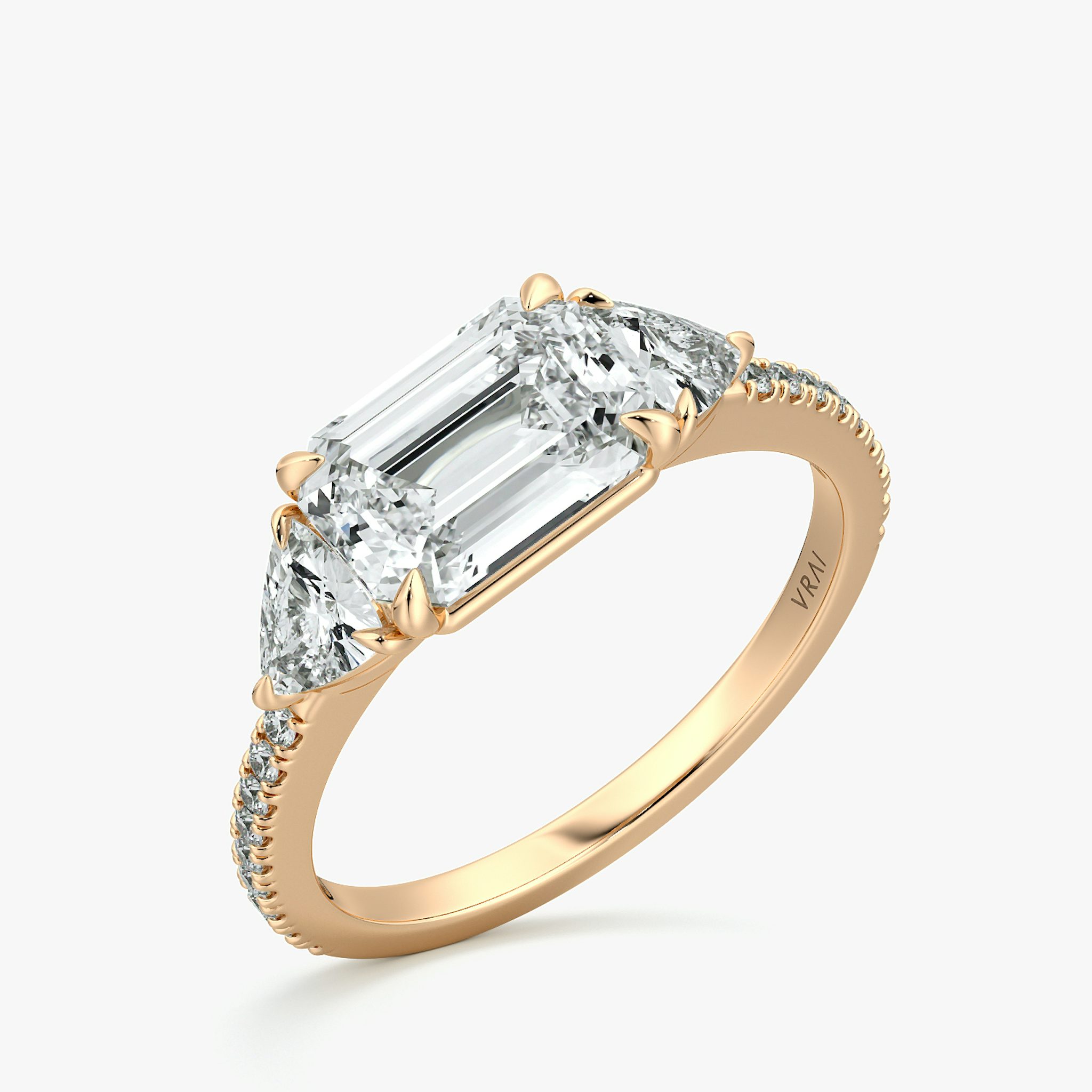 The Three Stone | Emerald | 14k | Rose Gold | bandAccent: Pavé | diamondOrientation: horizontal | sideStoneCarat: 0.25ct | sideStoneShape: Trillion | caratWeight: other