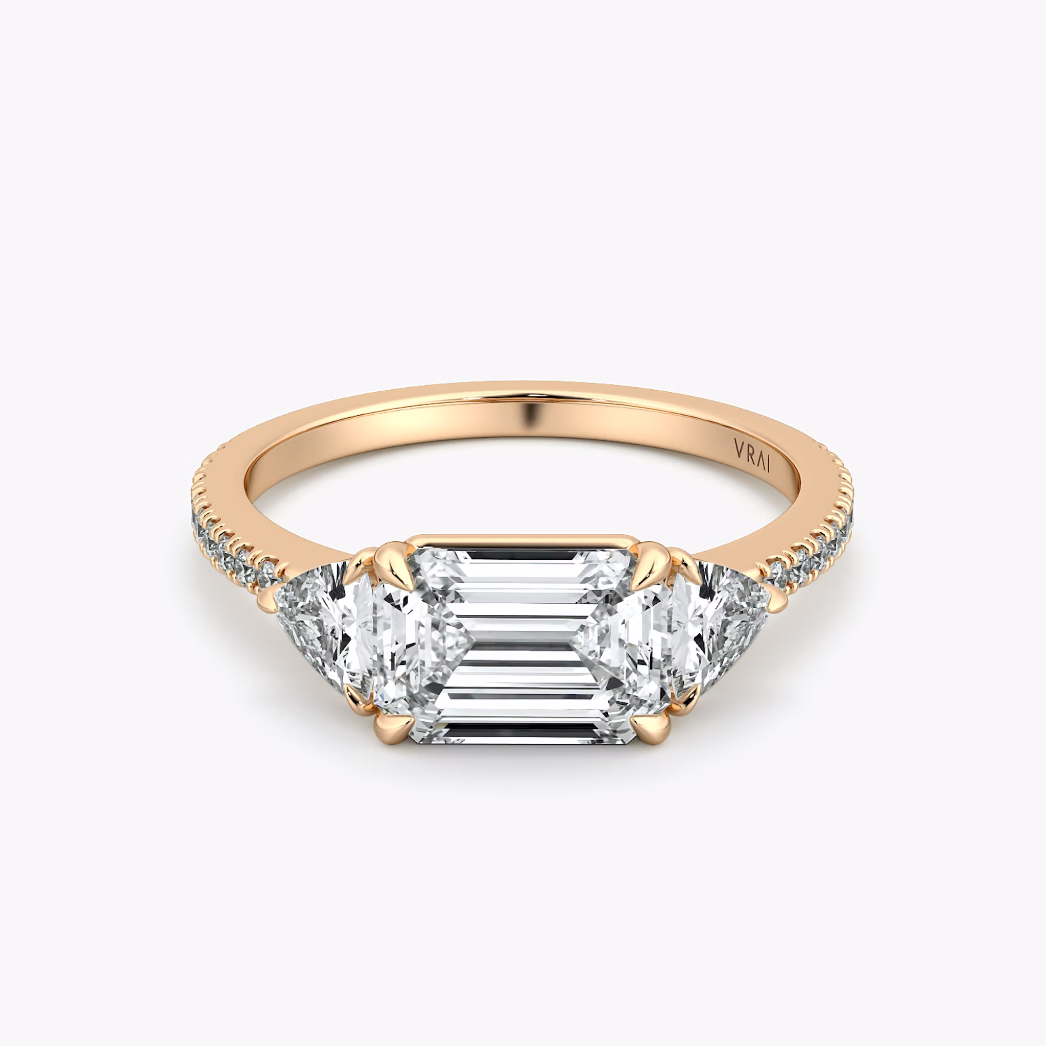 The Three Stone | Emerald | 14k | Rose Gold | bandAccent: Pavé | diamondOrientation: horizontal | sideStoneCarat: 0.25ct | sideStoneShape: Trillion | caratWeight: other