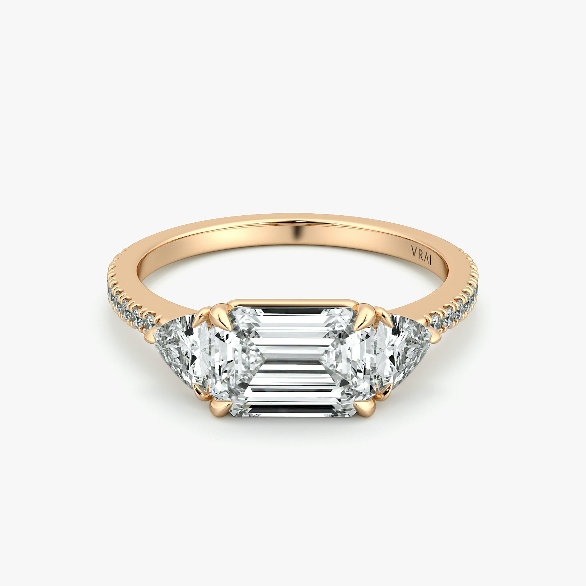 The Three Stone | Emerald | 14k | Rose Gold | bandAccent: Pavé | diamondOrientation: horizontal | sideStoneCarat: 0.25ct | sideStoneShape: Trillion | caratWeight: other